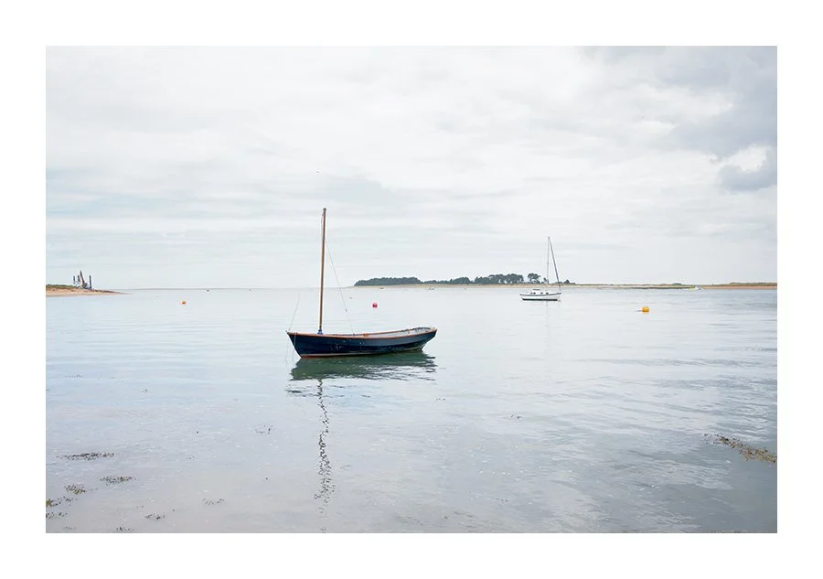 A Dinghy Moored in the Harbour Channel on a calm day. Wells
