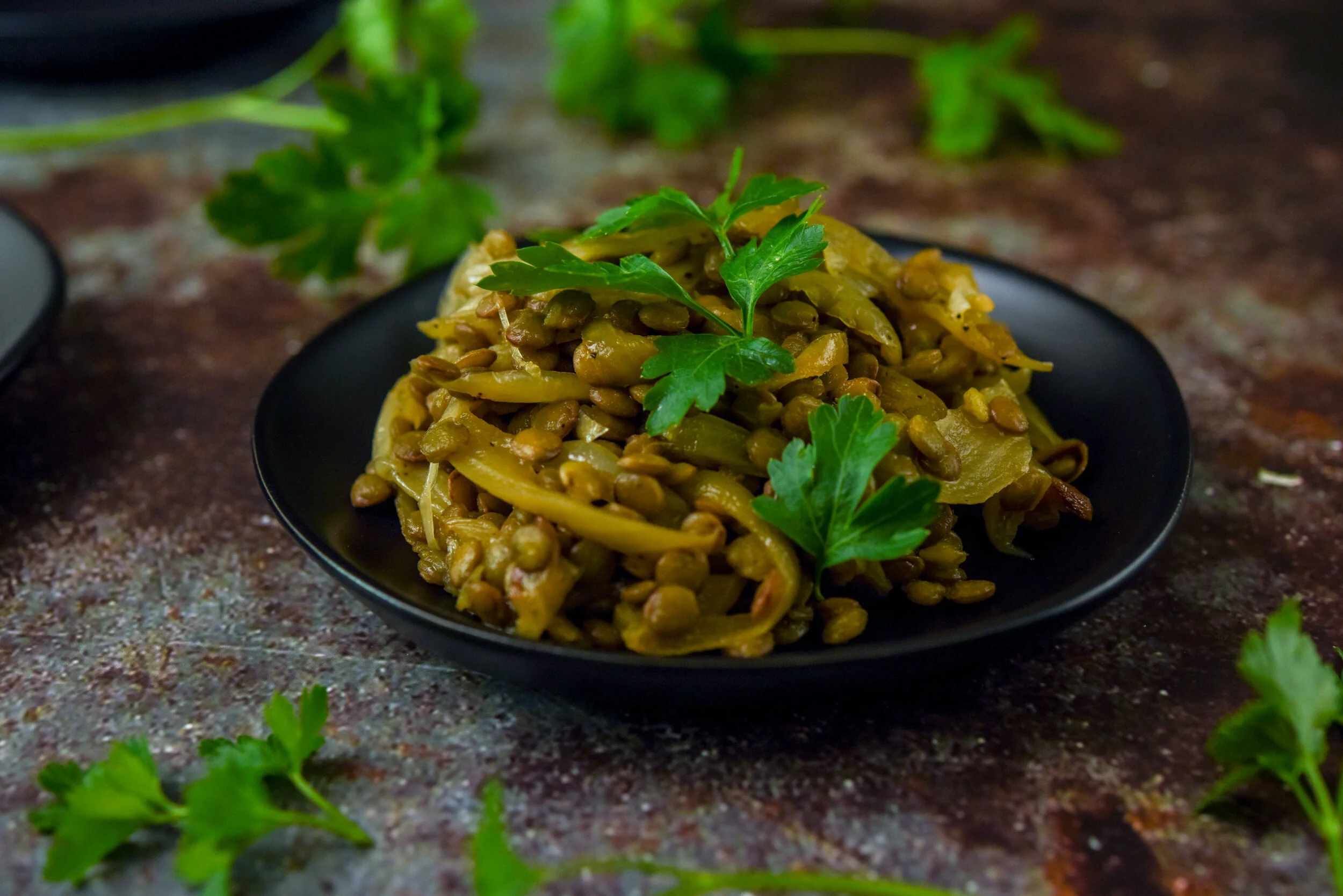 Lentils and Onions make a delectable side to any meal. Garnish with cilantro or parsley for an easy presentation upgrade to a main course. Food photography, food styling, and prop styling by Megan Crist.