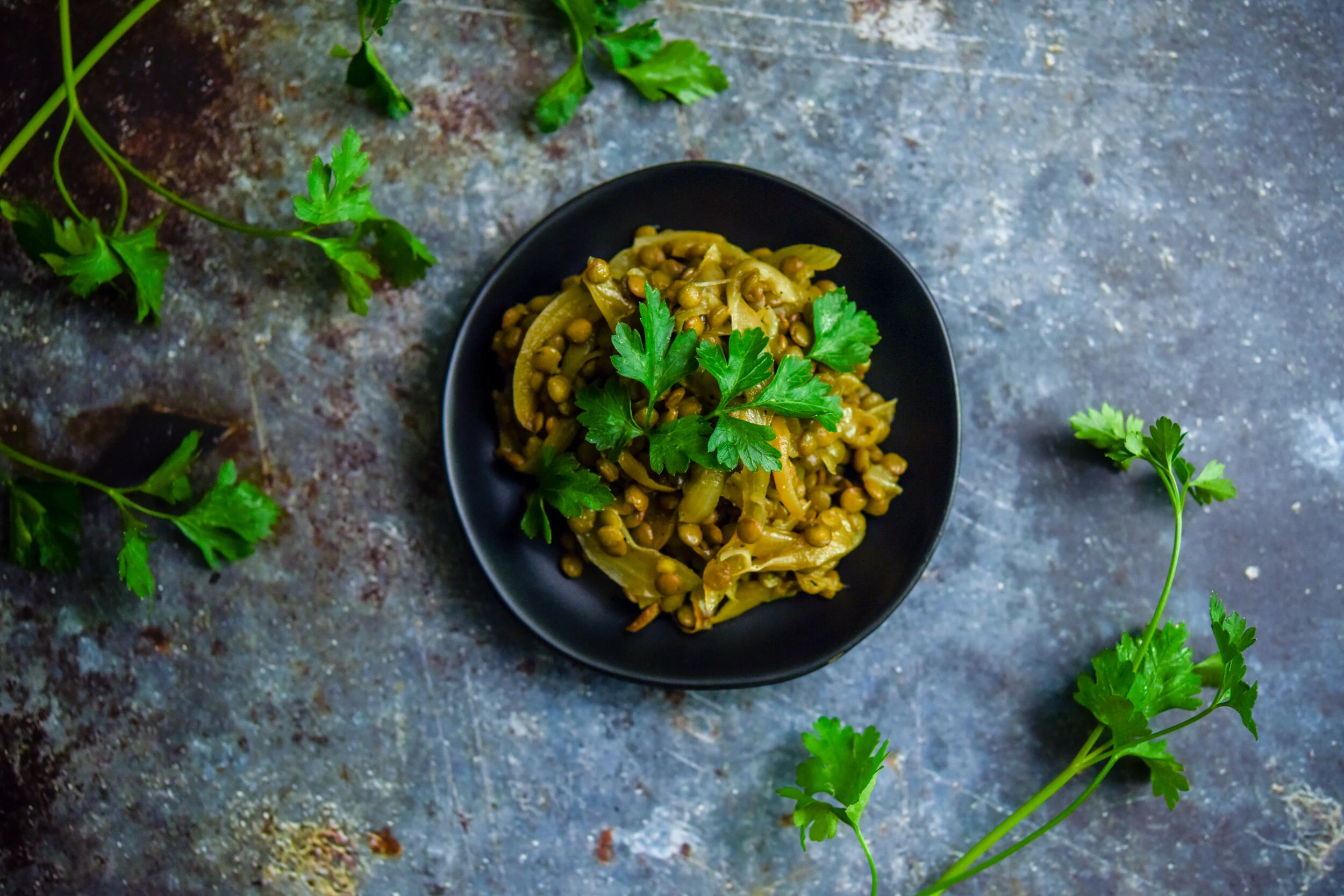 Lentils and onions make a unique flavorful and protein packed vegetarian side. Food photography, food styling, and prop styling by Megan Crist.