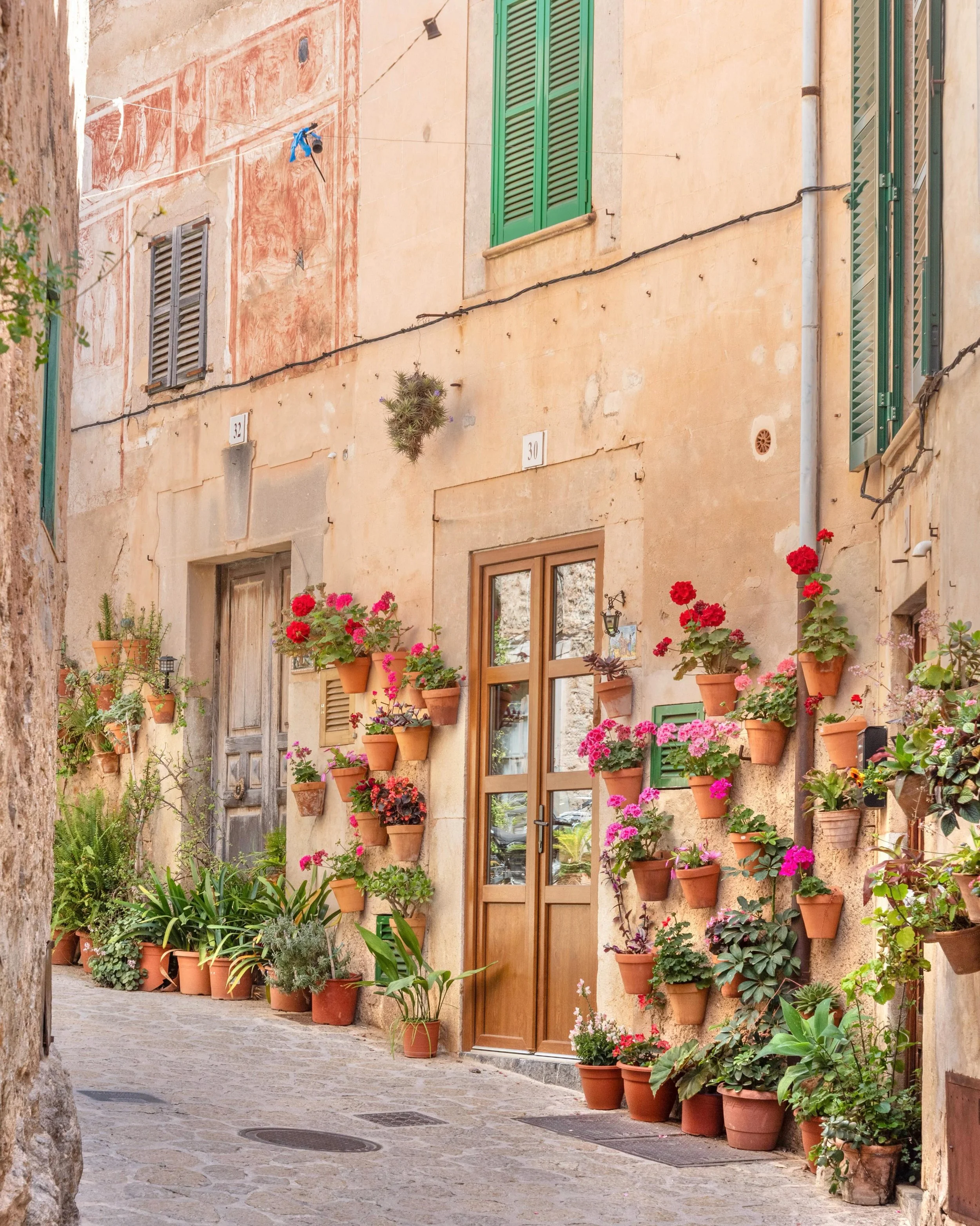 Valldemossa is a breathtaking, idyllic village nestled in the high Serra de Tramuntana mountains of Mallorca, Spain. Located just a 20-to-30-minute scenic drive north of Palma, it stands as the highest town on the island. 

The village is universally