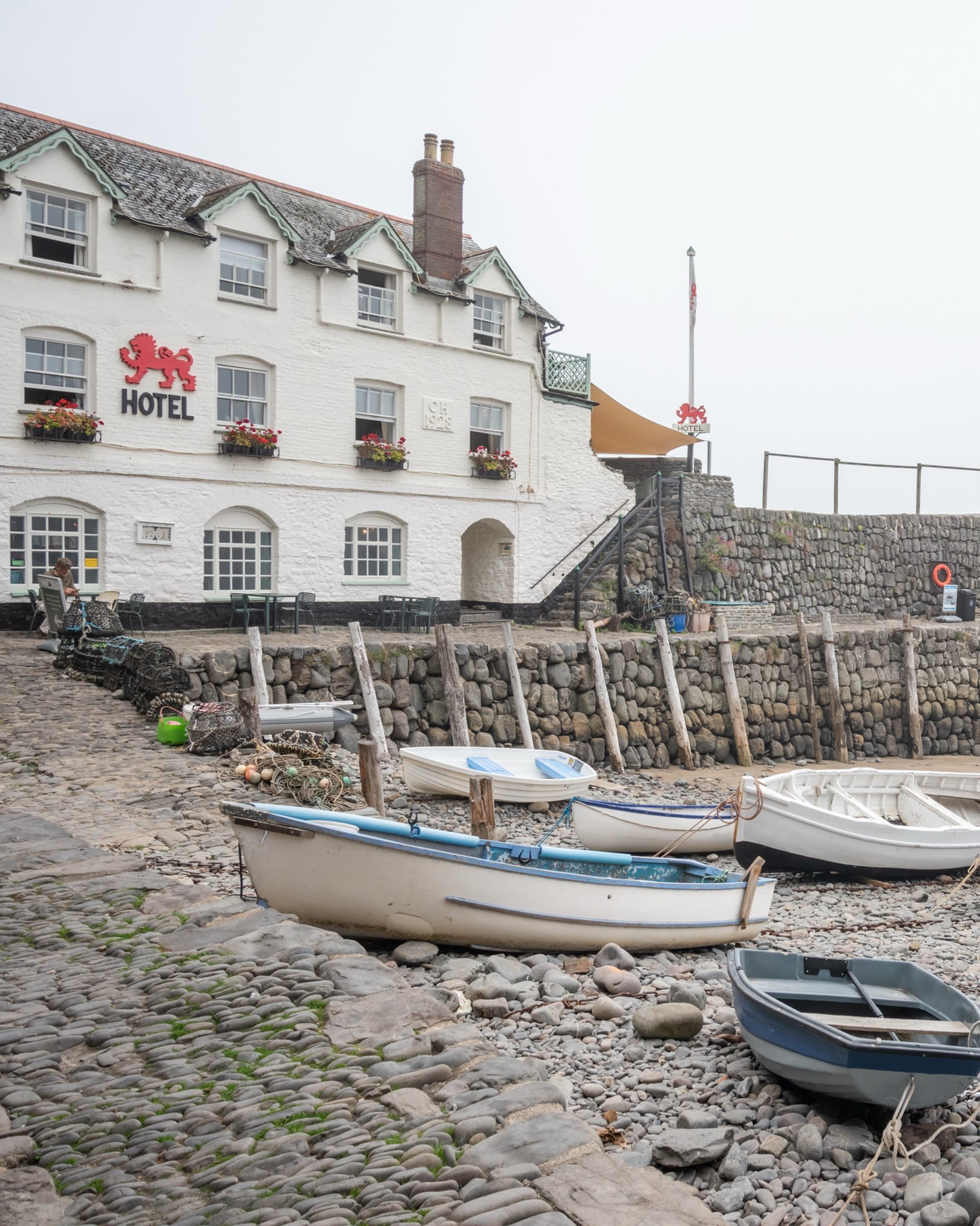 Clovelly Harbour is a historic 14th-century quay nestled at the base of a steep, 400-foot wooded cliff in North Devon. Famous for its traffic-free, cobbled streets where goods are transported by sledges and donkeys, the harbour provides a picturesque