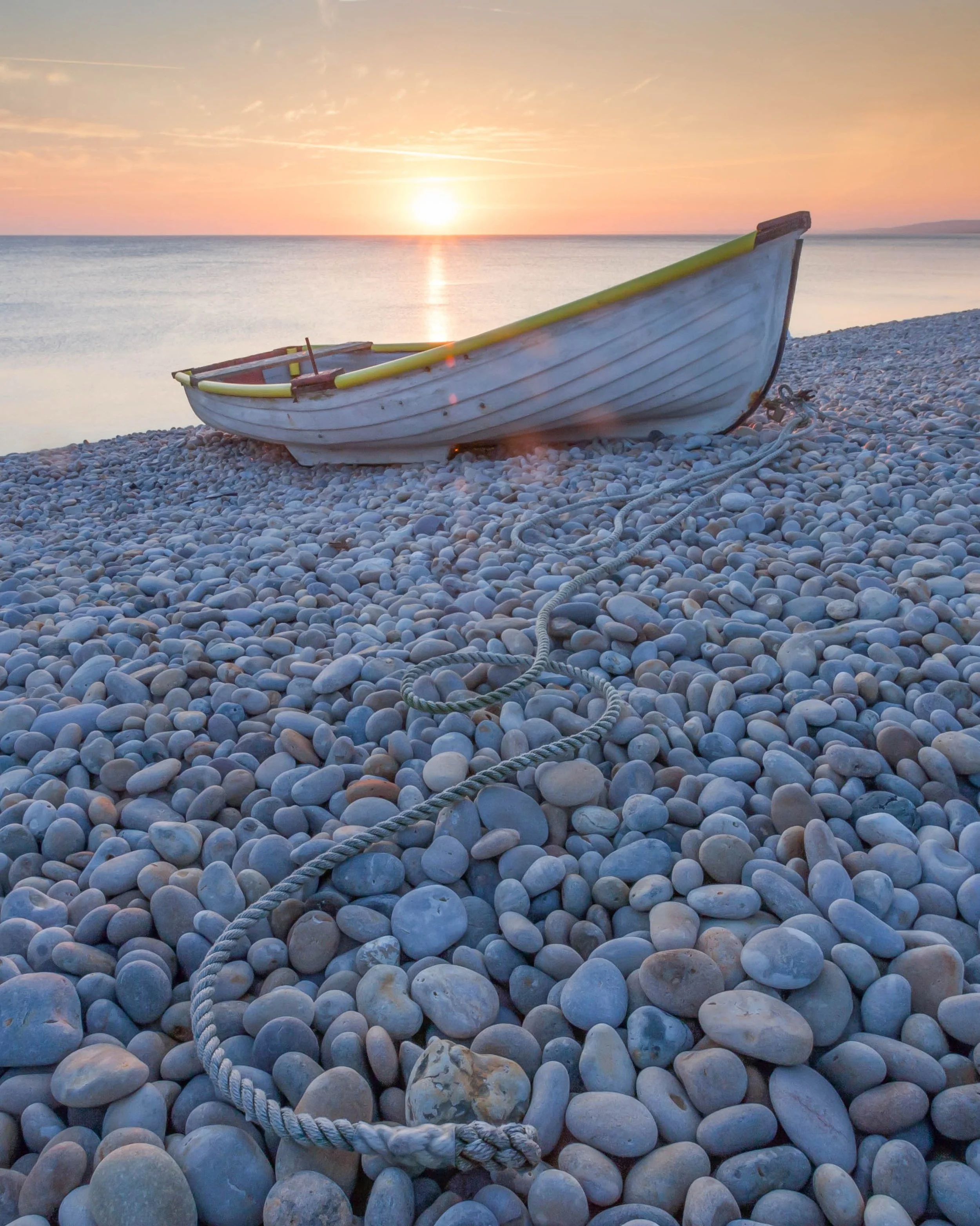 Chesil Beach (also known as Chesil Bank) is one of the most striking natural features in the UK. Located on the Dorset coast this vast, sweeping barrier beach stretches for roughly 18 miles (29 km) from West Bay to the Isle of Portland, forming part 