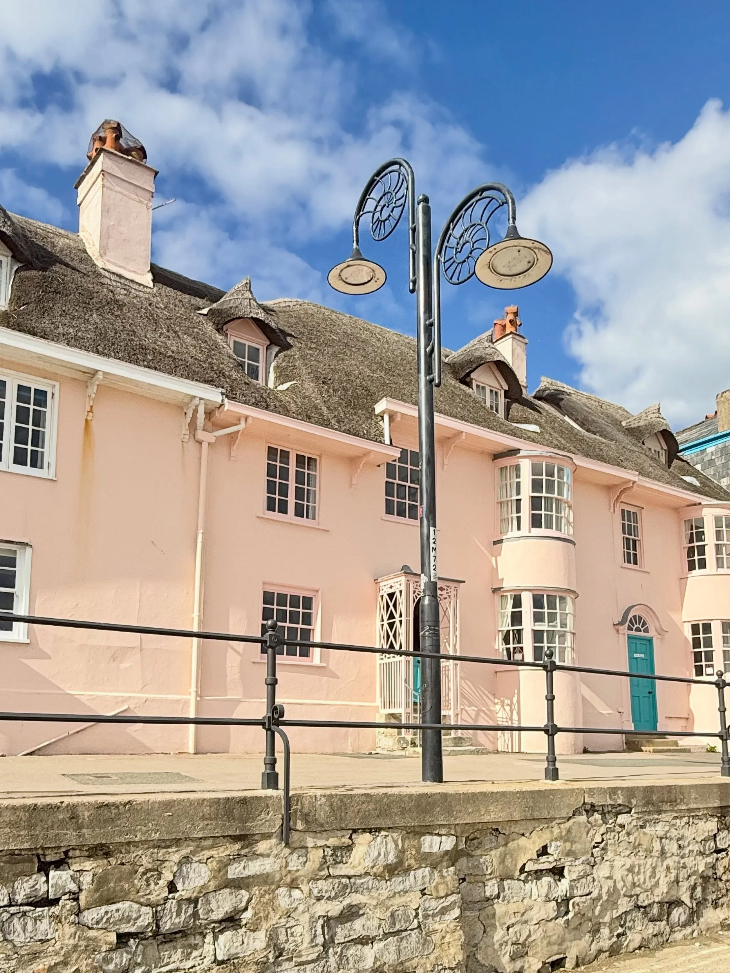 The promenade at Lyme Regis - primarily along Marine Parade - features a mix of Georgian, Regency, and early 20th-century coastal architecture alongside modern seafront facilities.
