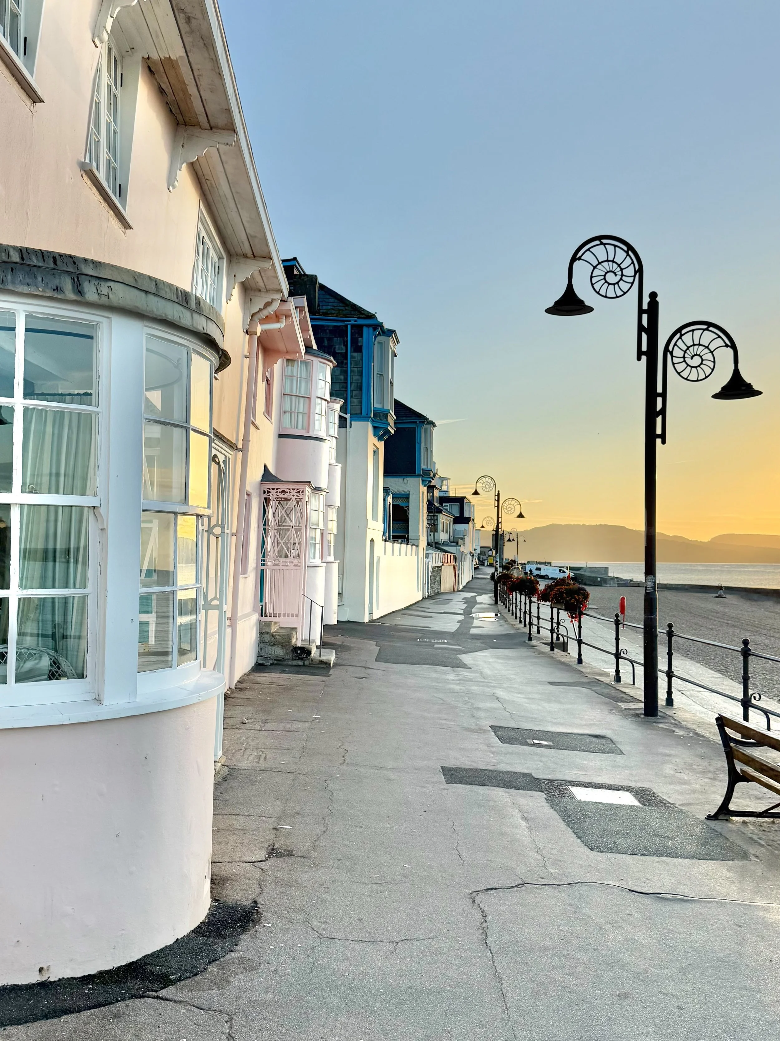 Along Marine Parade and the seafront of Lyme Regis, Dorset, standard street furniture gives way to a homage to the Jurassic Coast. The town&rsquo;s lampposts feature wrought-iron brackets crafted in the distinctive, coiled shape of ammonite fossils.
