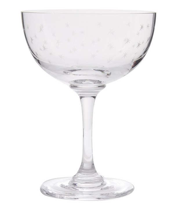 THE VINTAGE LIST Set of Six Stars Champagne Coupes - £75.00 True to British heritage, The Vintage List Champagne Coupes are inspired by 19th Century and early 20th Century English glassware, providing a vintage aesthetic to modern dining. Cut from fine crystal glass, these exquisite hand-engraved glasses feature a dainty and feminine engraved star pattern. www.libertylondon.com