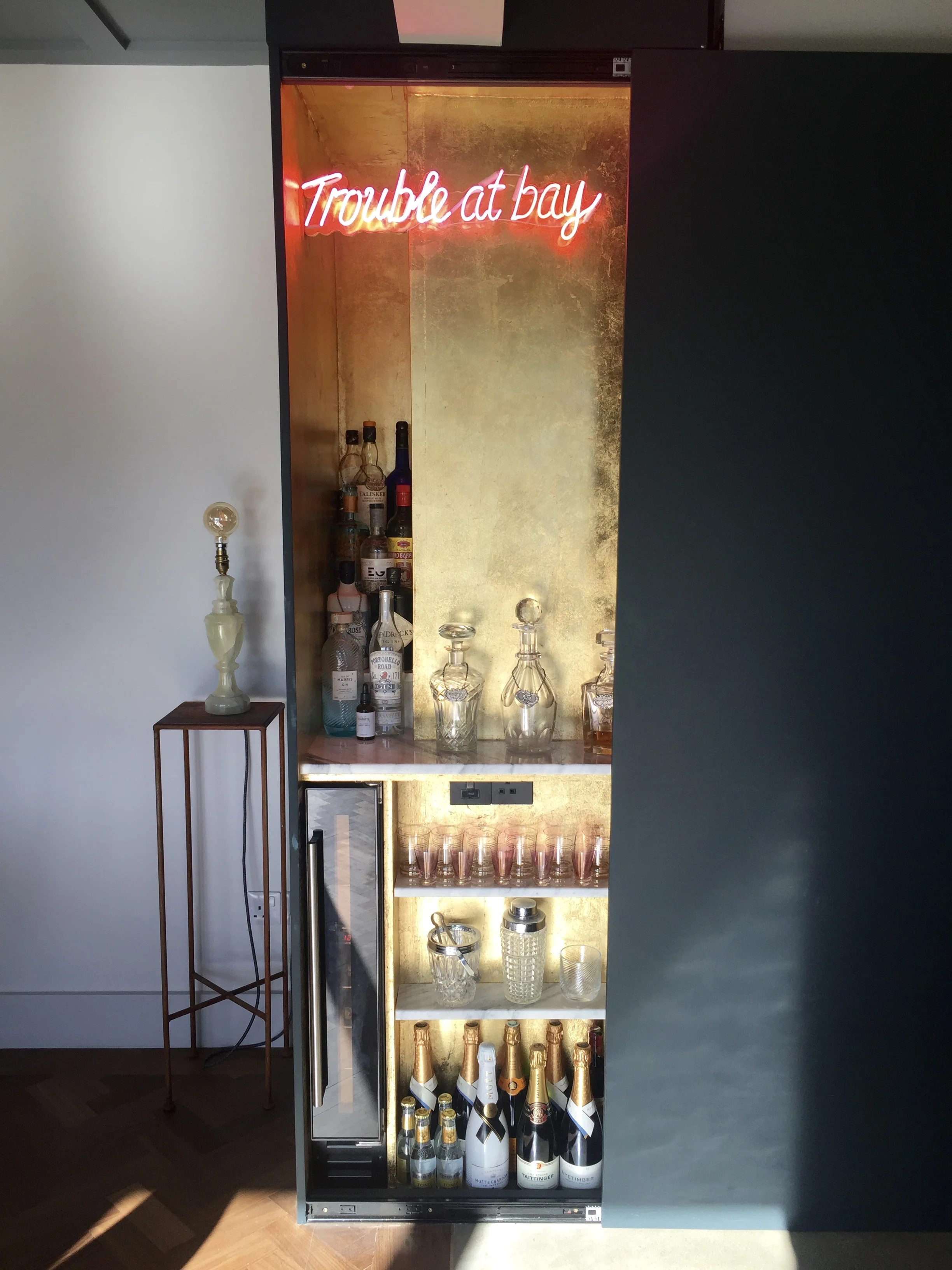 Behind the Black Blue sliding wall Michaela has added gold leaf, neon and carrera marble shelves to make this fabulously stylish hidden bar area @theoldpiggery
