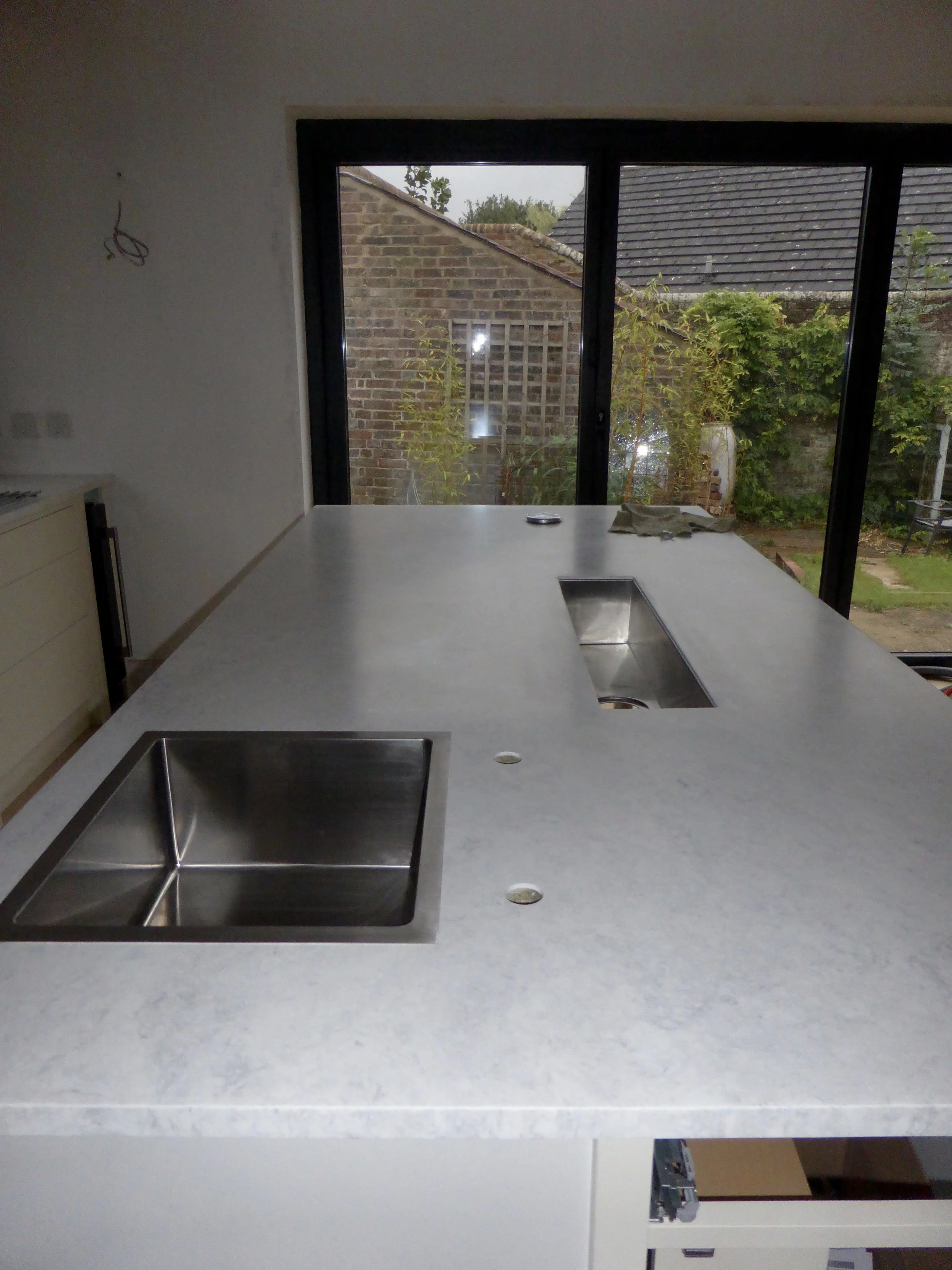 Both of the sinks fitted and the pop up plug socket at the other end of the island.....