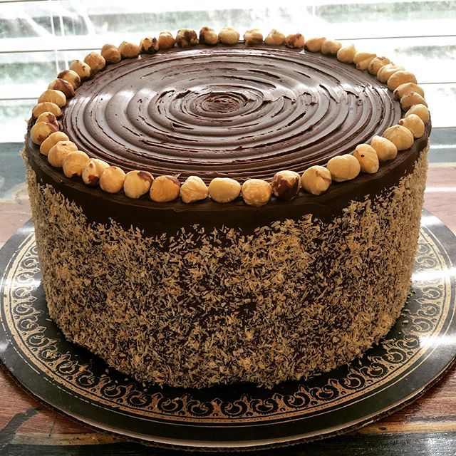 Chocolate, coconut and hazelnut. Three layers of decadent coconut cake smothered in dark chocolate ganache and laced with hazelnuts. In celebration of college graduation. Congrats! .
.
.
.
.
.
.
#dapperfox #graduationcake #chocolate #hazelnut #coconu