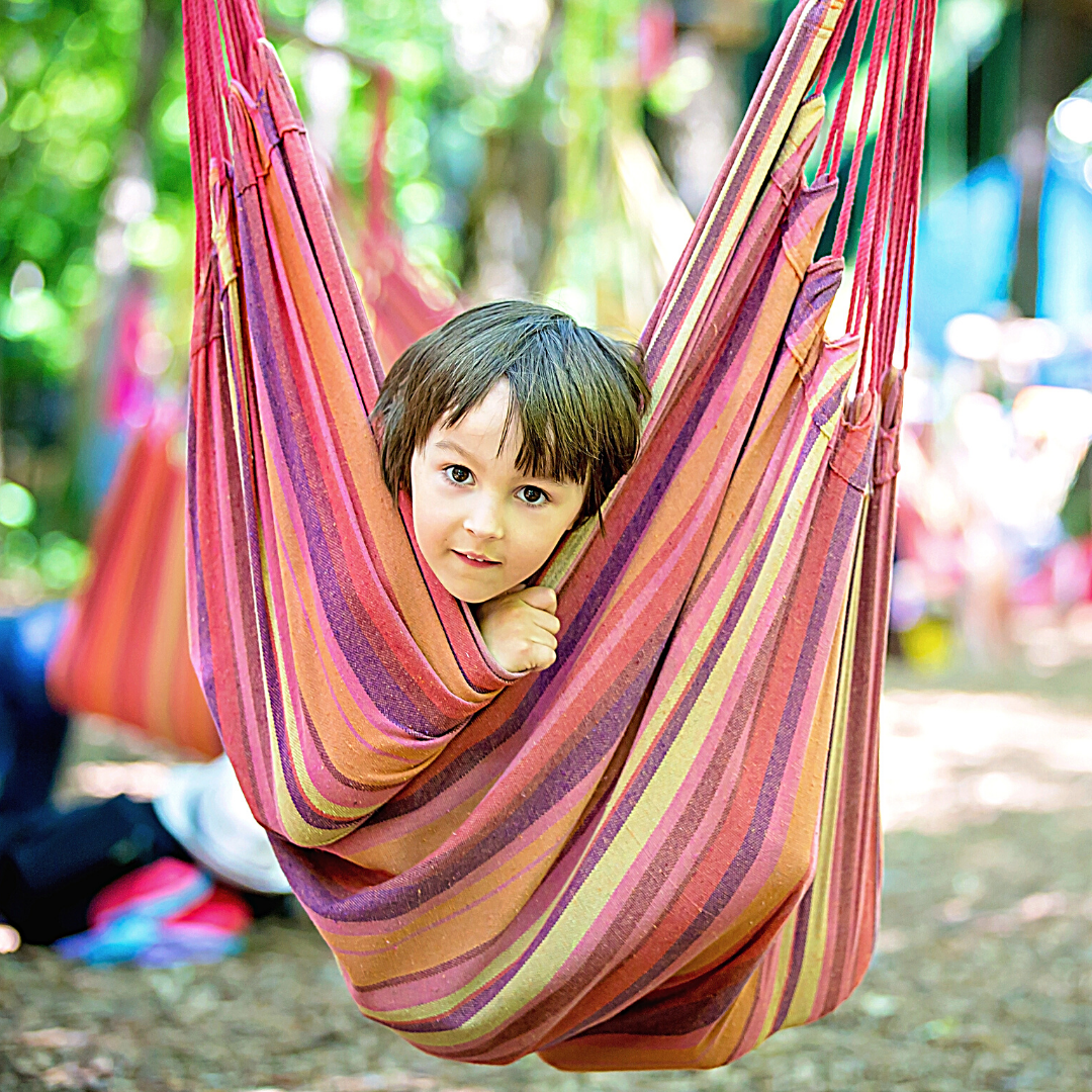 Child looking out of a hammock swing