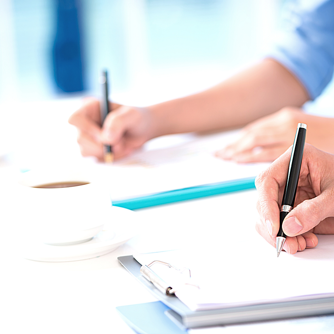 Taking notes in a notebook.