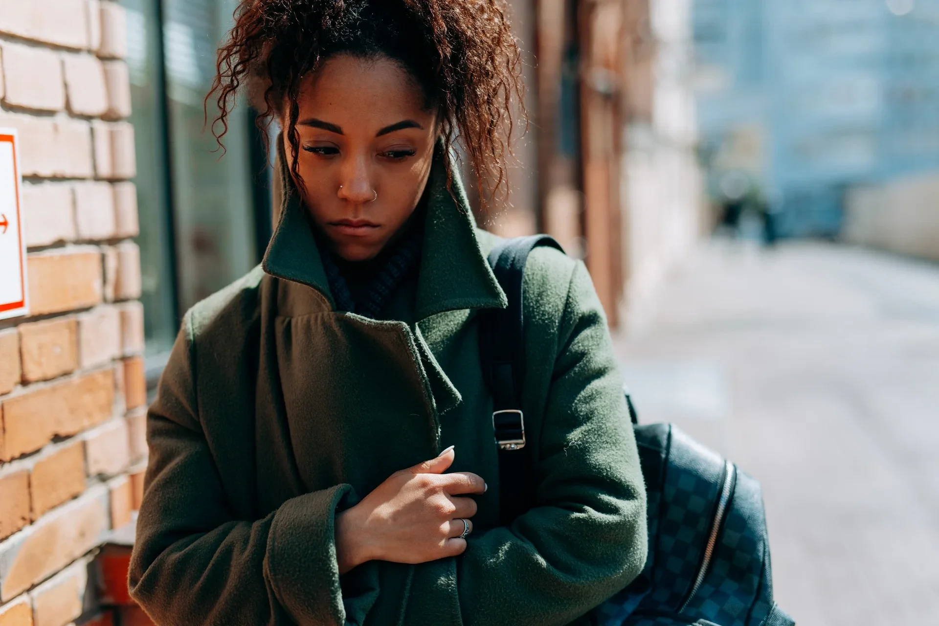 A high-functioning professional woman masking her inner burnout and imposter syndrome with outward confidence.