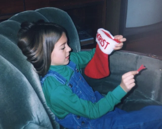 Removing the name "Kristy" from my stocking, circa 1993. Photo by my mom, Nancy Hopps
