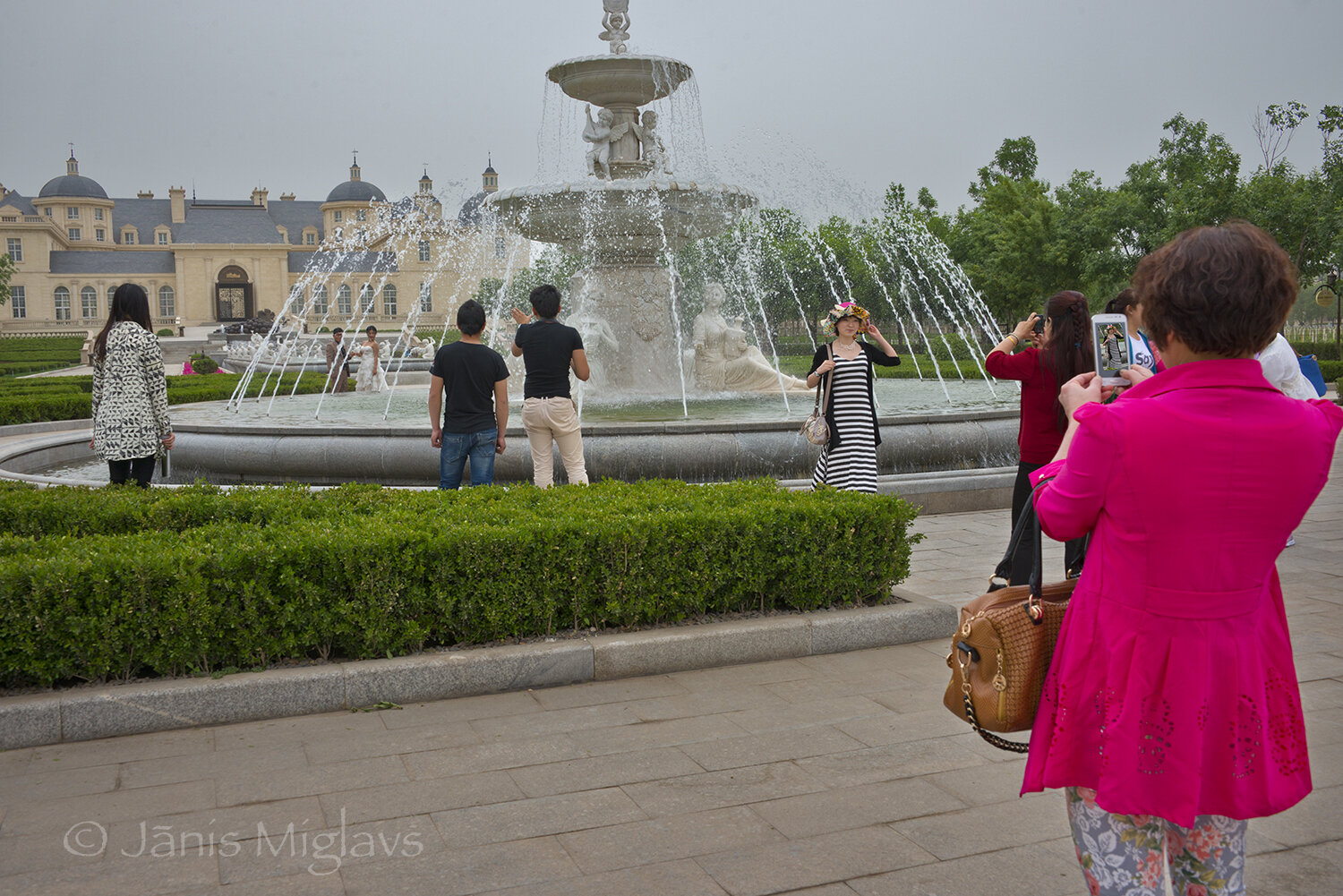 Chinese tourists photographing at one of the fountains.