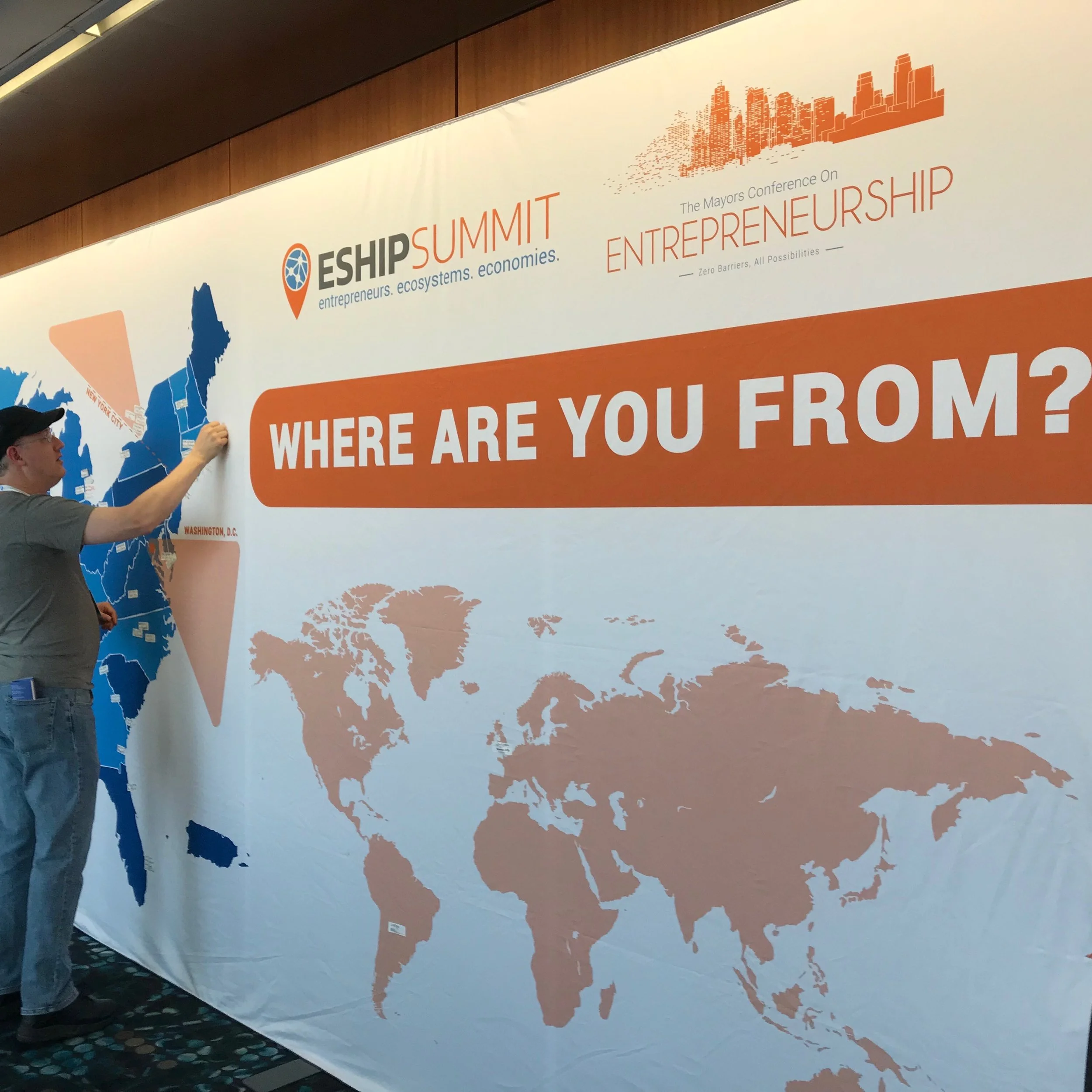 An attendee of the ESHIP conference adds his hometown to a map of the world.