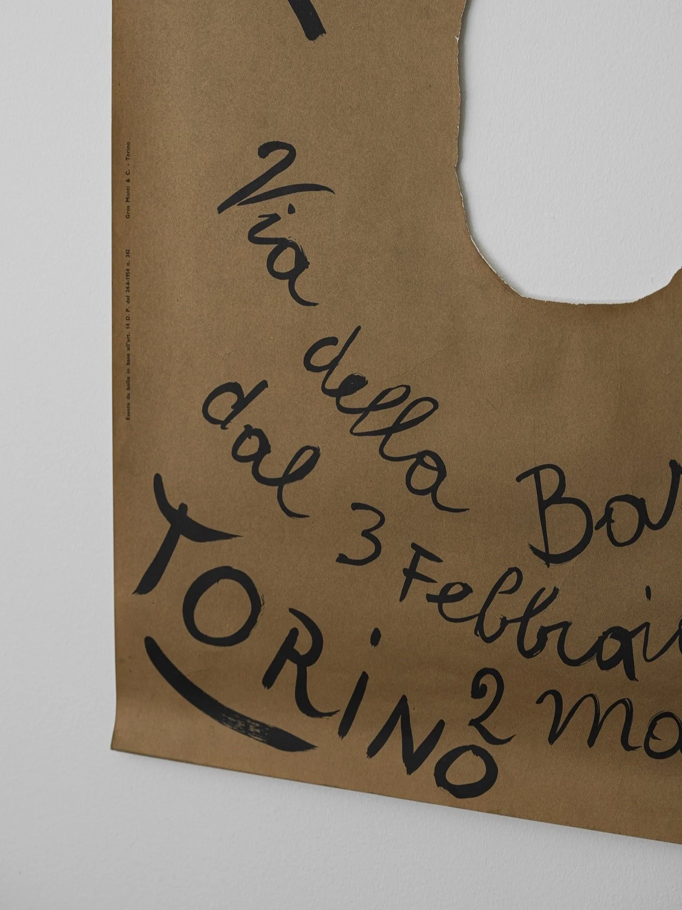 Original 1962 Lucio Fontana exhibition poster with hand-drawn black text on brown kraft paper and signature central cut-out.