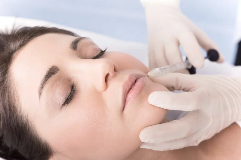 Lady having lip fillers at the dentist