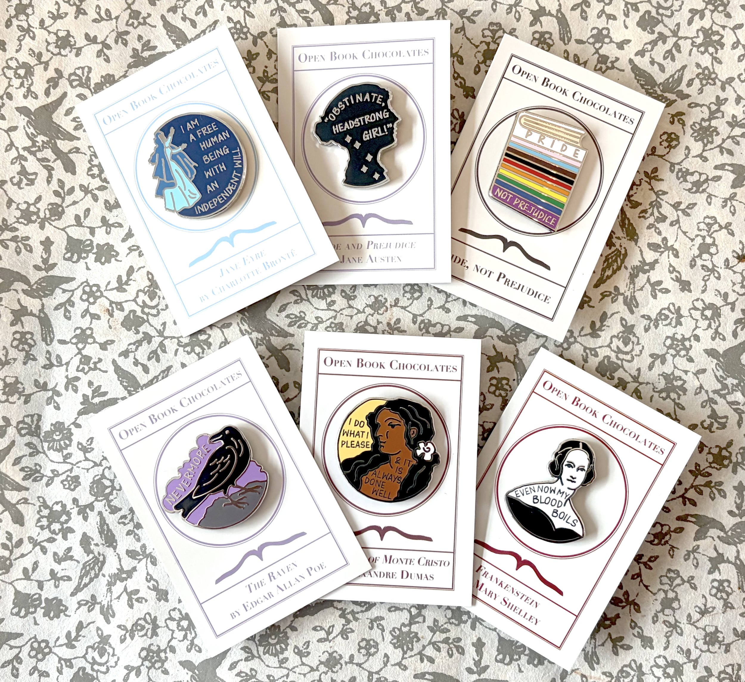 2 - OBC Enamel Pins All 6 Designs Landscape Cropped.png