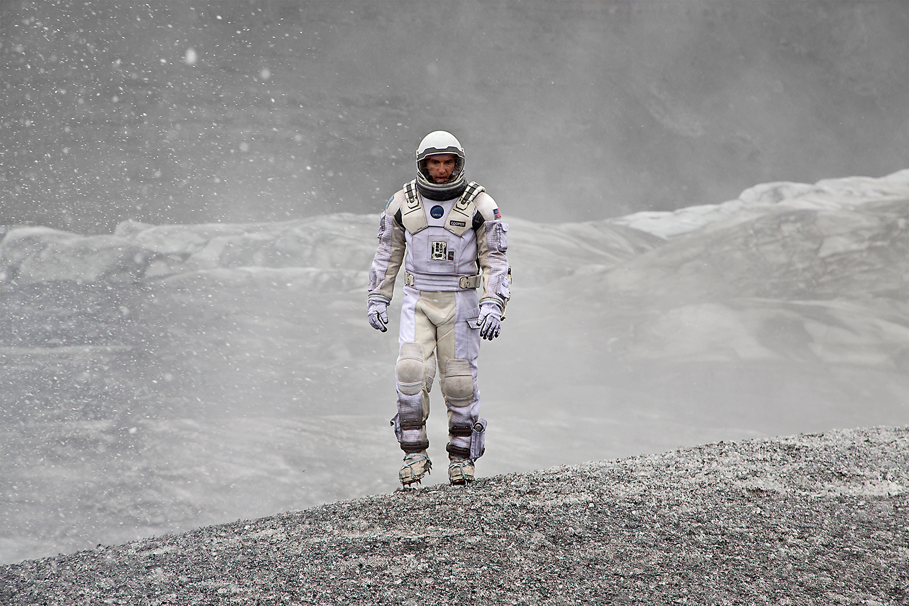 Coop (Matthew McConaughey) wanders the frozen-cloud surface of the planet Mann