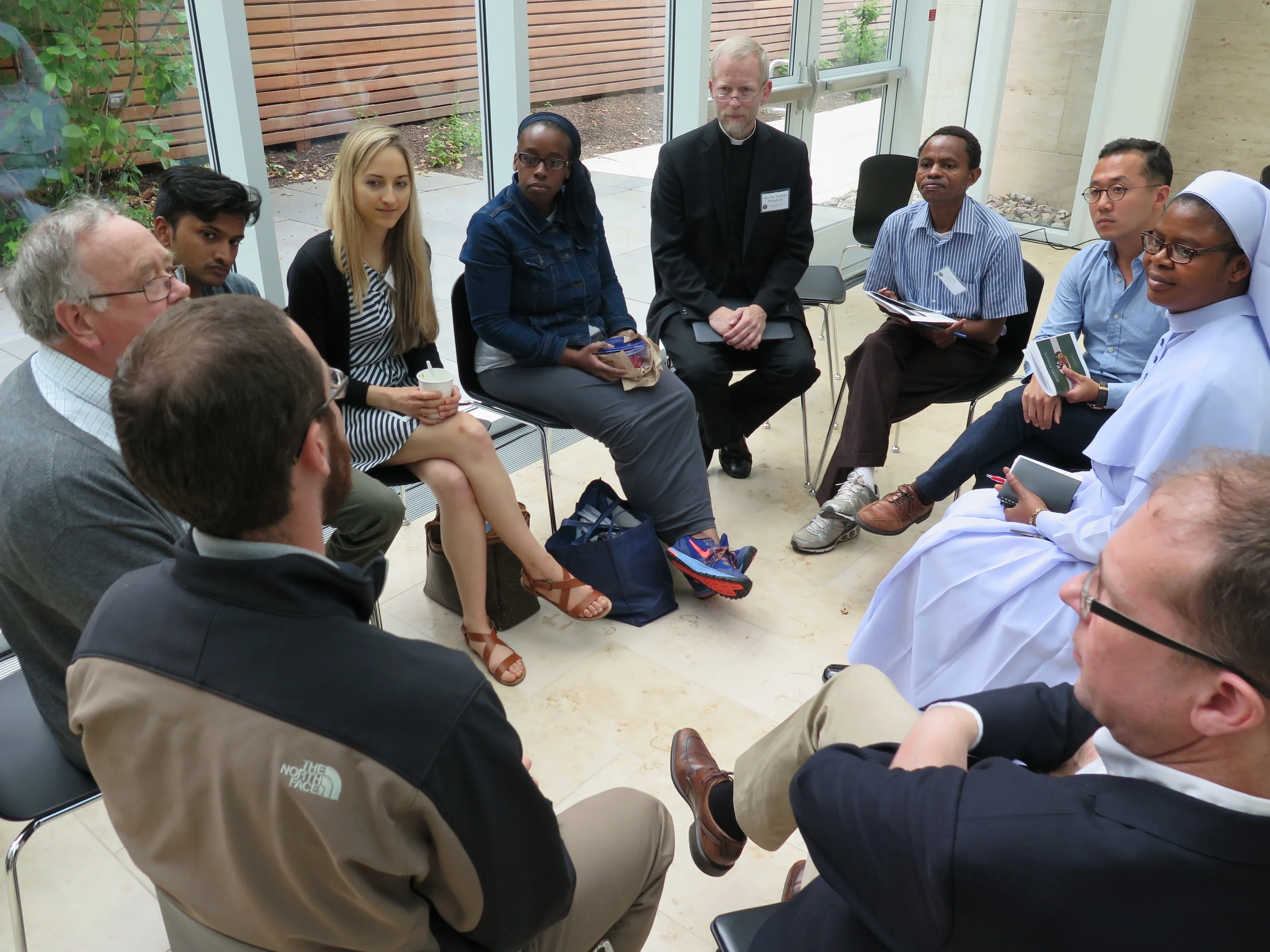 Scholars and professors participating in discussion at Magi's 2017 summer seminar