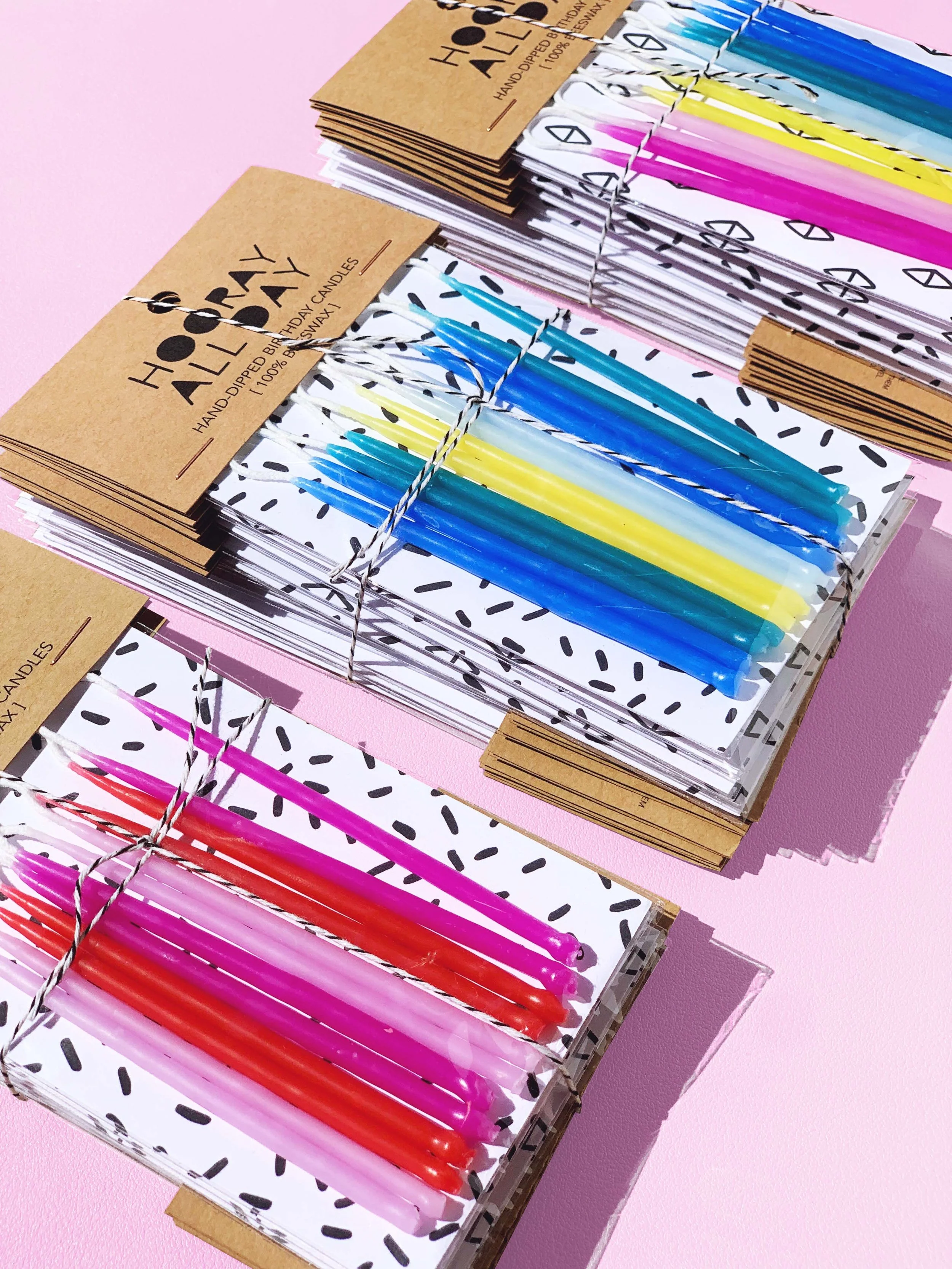 Three Packs of Candles all Colors Product Shot on Pink.jpg