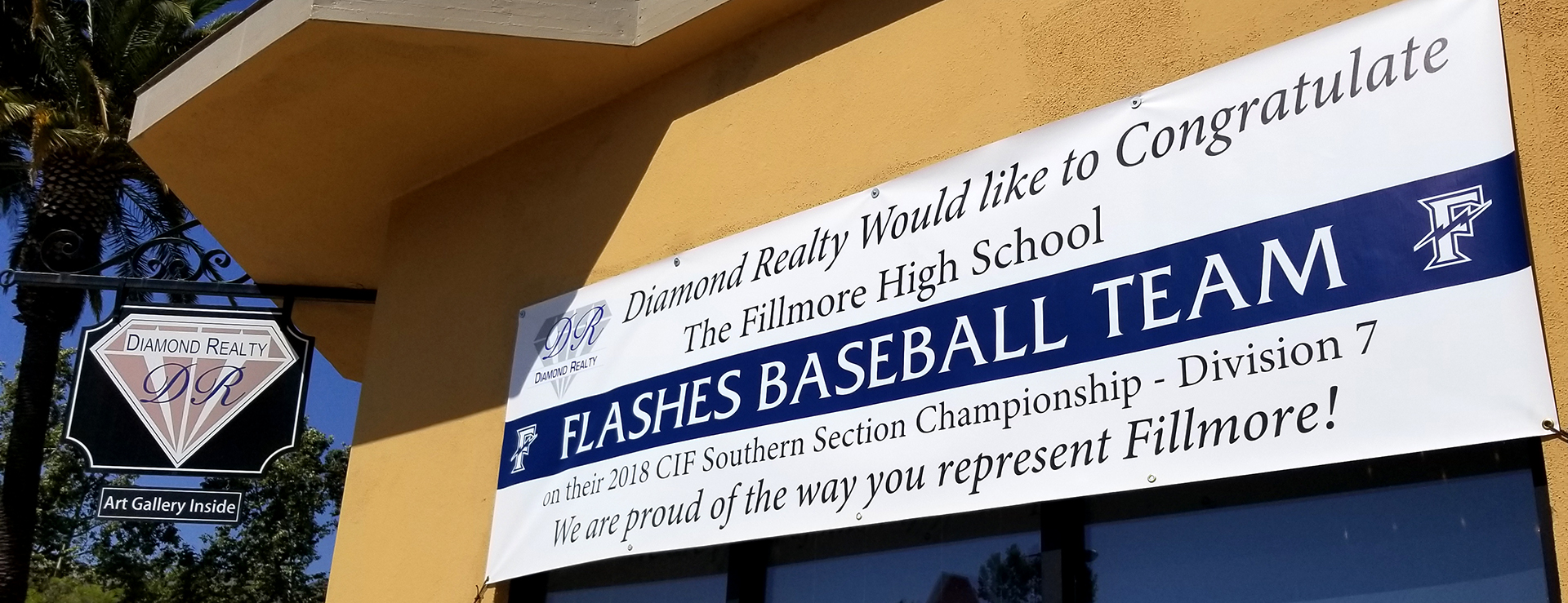 The FHS Boys Baseball CIF Championship banner in front of Diamond Realty's office in Fillmore.