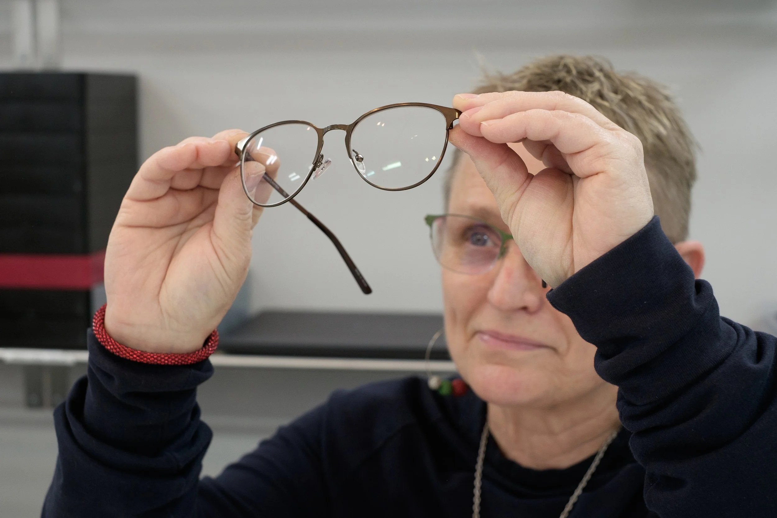 staff examining eyeglasses