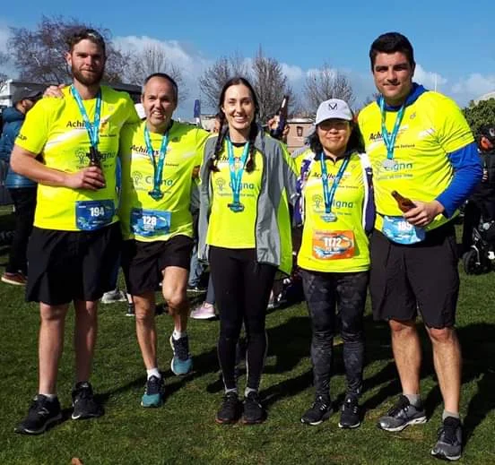 Rotorua athletes and guides with their finishes medals at the Taupo Marathon event