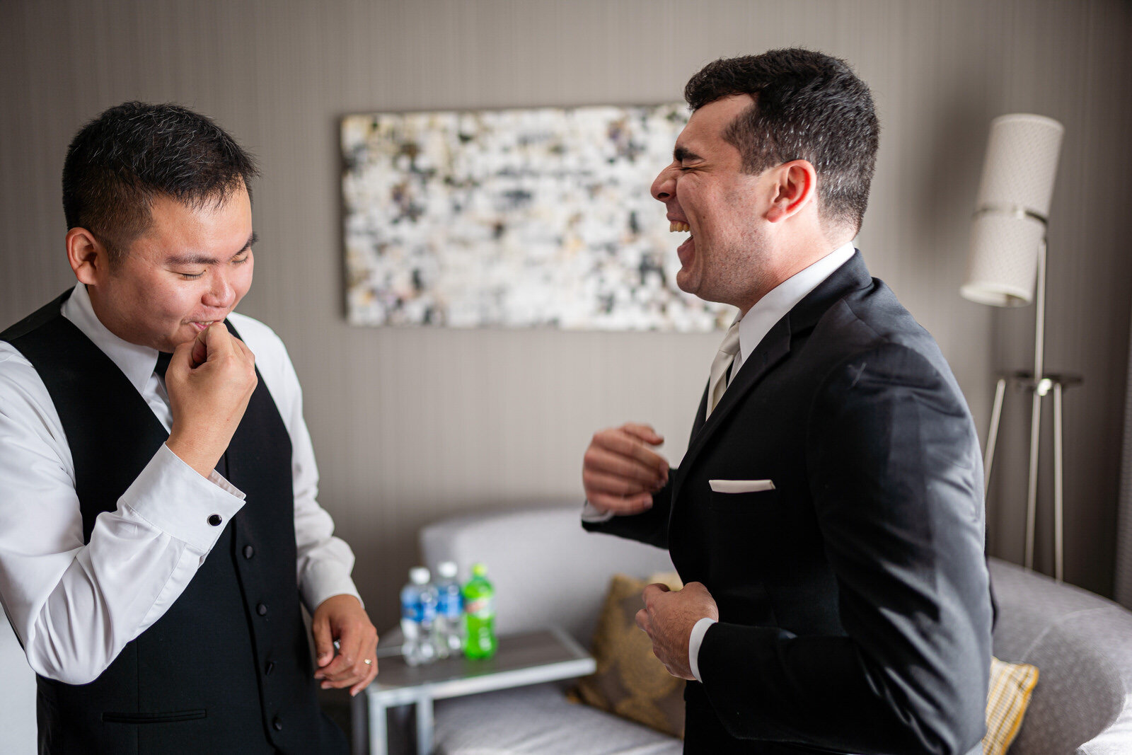 A groom and his best man laughing while getting ready in Allentown PA