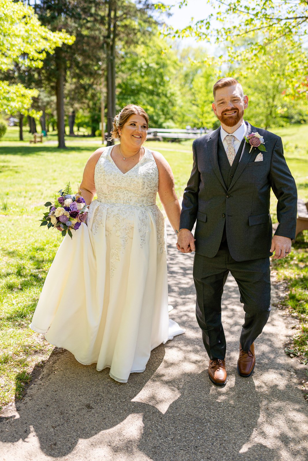 A happy couple walk through a park in Philadelphia PA