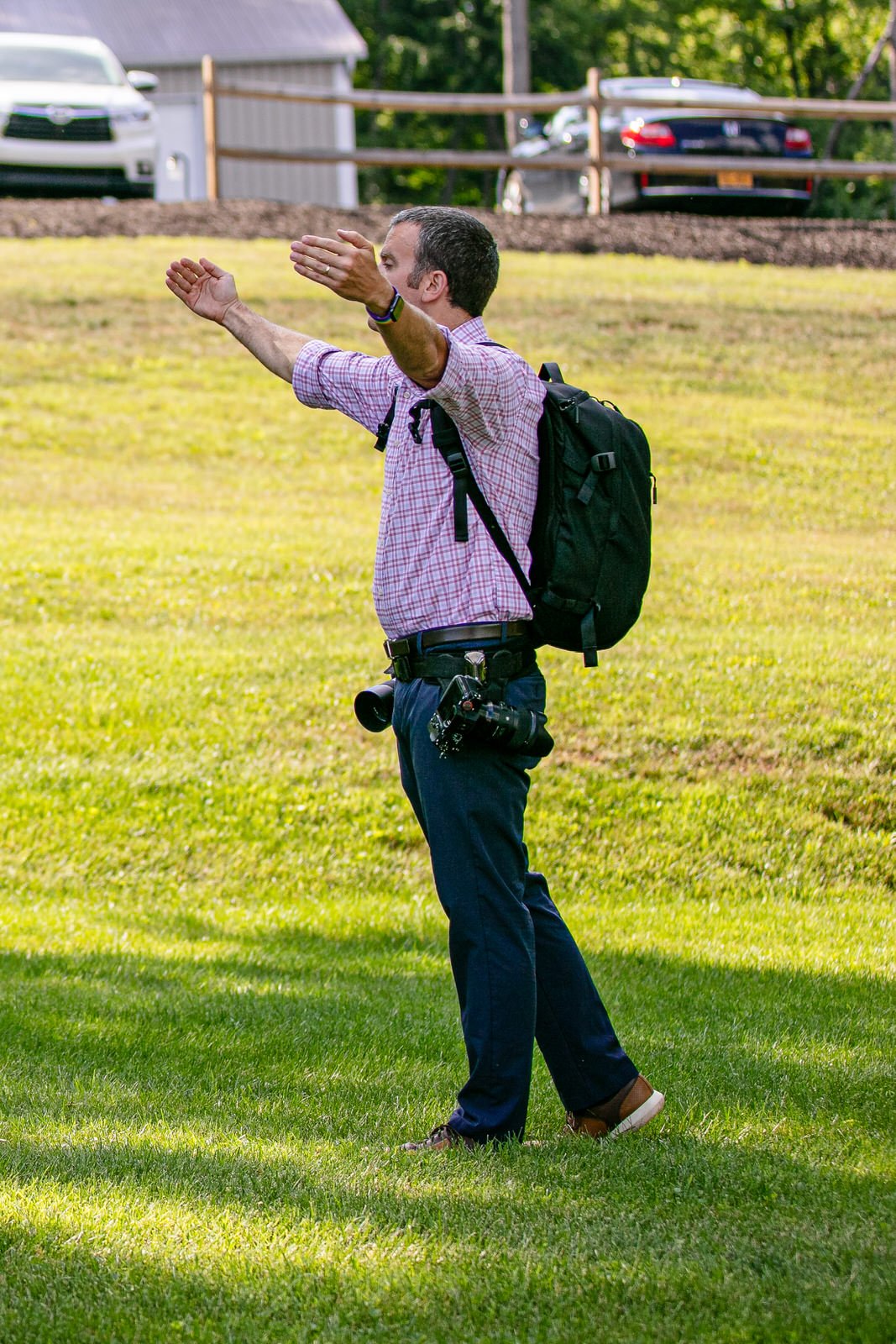 Colin Hayden Photo directing people with his cameras and backpack