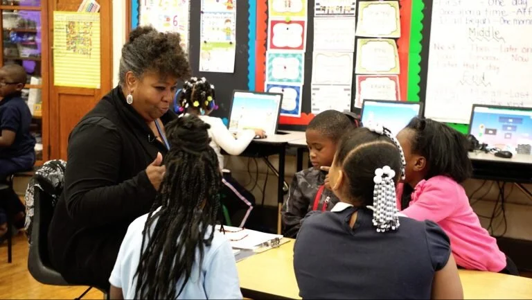 Ms. Gillespie reads aloud to a group of students during class last year
