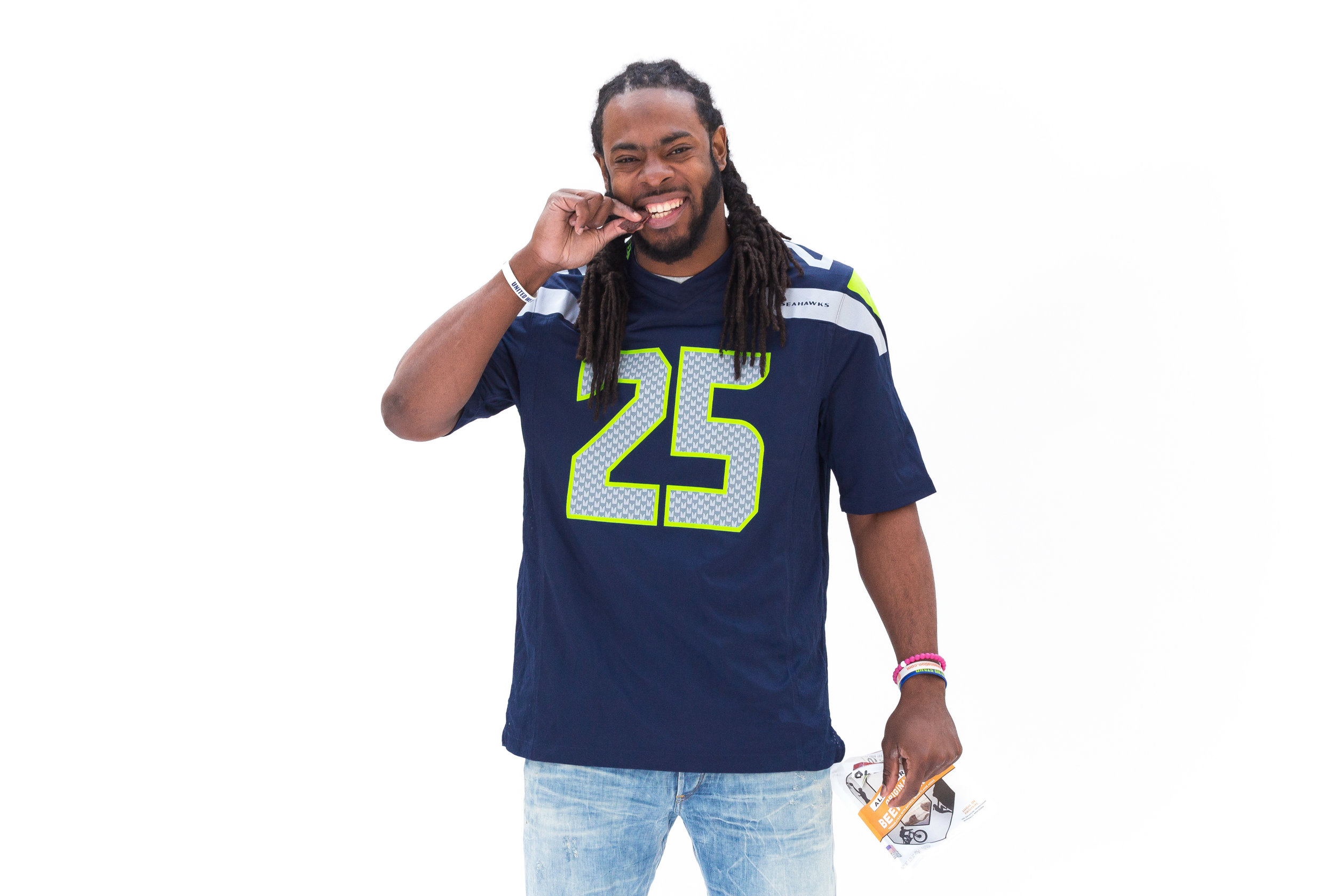 NFL cornerback Richard Sherman wearing Seattle Seahawks jersey holding Oberto beef jerky as part of Oberto brand ambassador campaign managed by Mapped Social