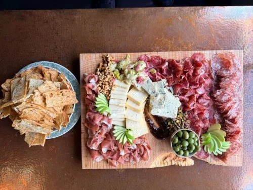 A bowl of crackers and a charcuterie board at Fire and The Feast in Edmonds WA