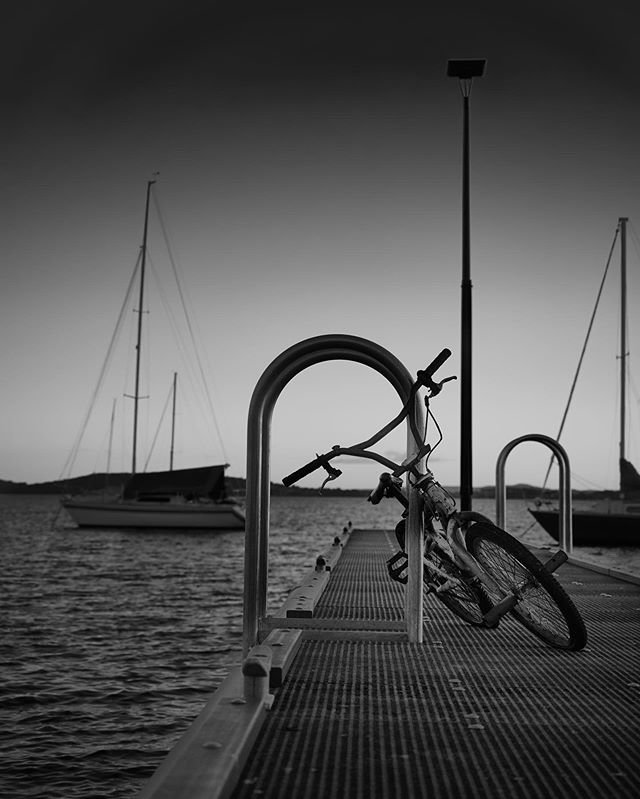 Can&rsquo;t help but wonder where the rider went. 🚲
Nothing but still water, boats and sunset. 🚲
⚫️⚪️ BW or 🌈 ROYGBIV?
🚲

#OlympusInspired
#NikCollection 
#captureone
#BlackandWhiteIsWorthTheFight
#bnw_sundays
#blackandwhite
 #bw 
#monochrome
 #l