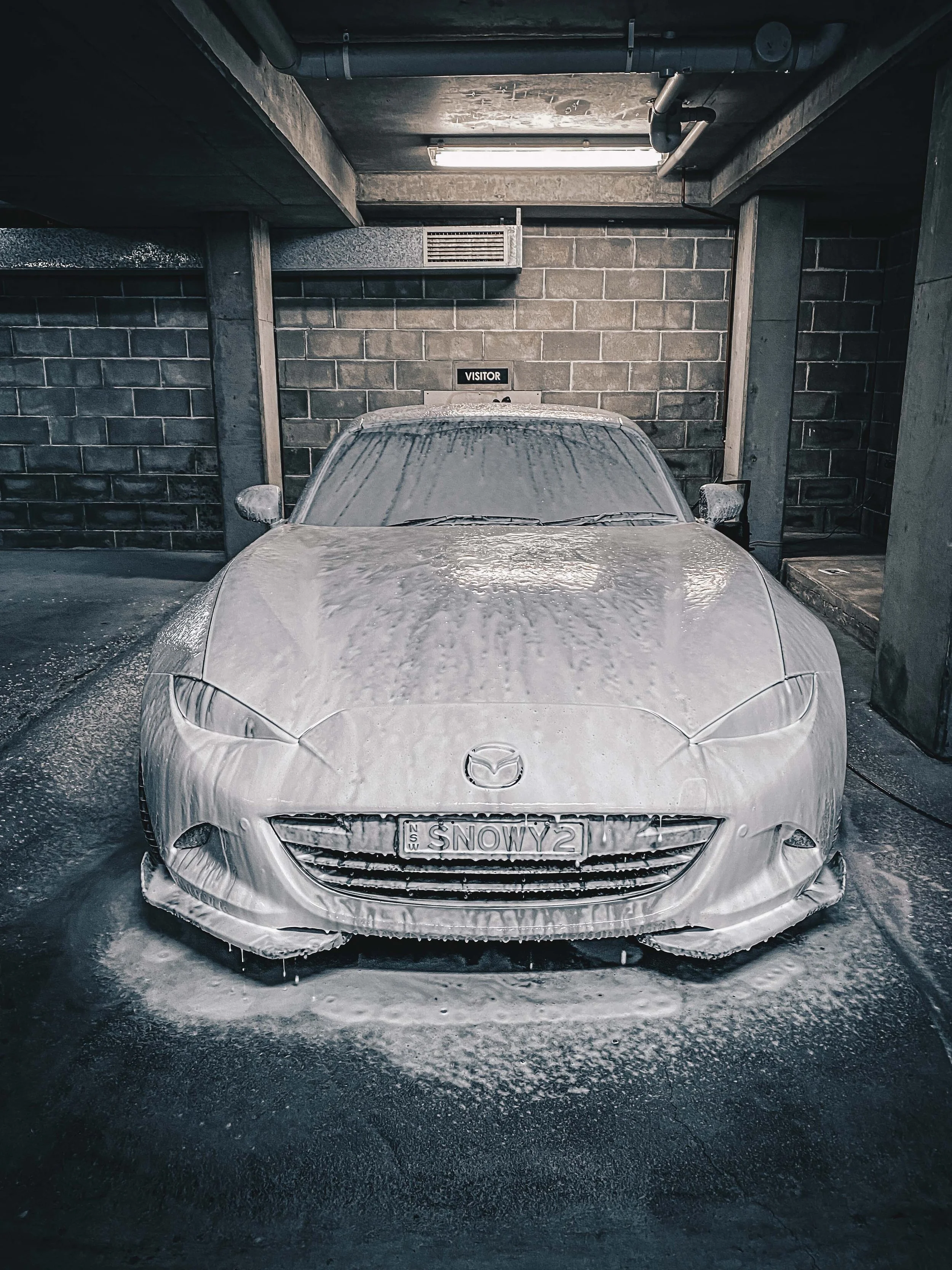 White Mazda MX-5 completely covered in thick pH-neutral snow foam during mini detail package prep. Foam pre-wash safely lifts dirt before hand wash. Mobile detailing by Shibbi Automotive Care in Rose Bay.