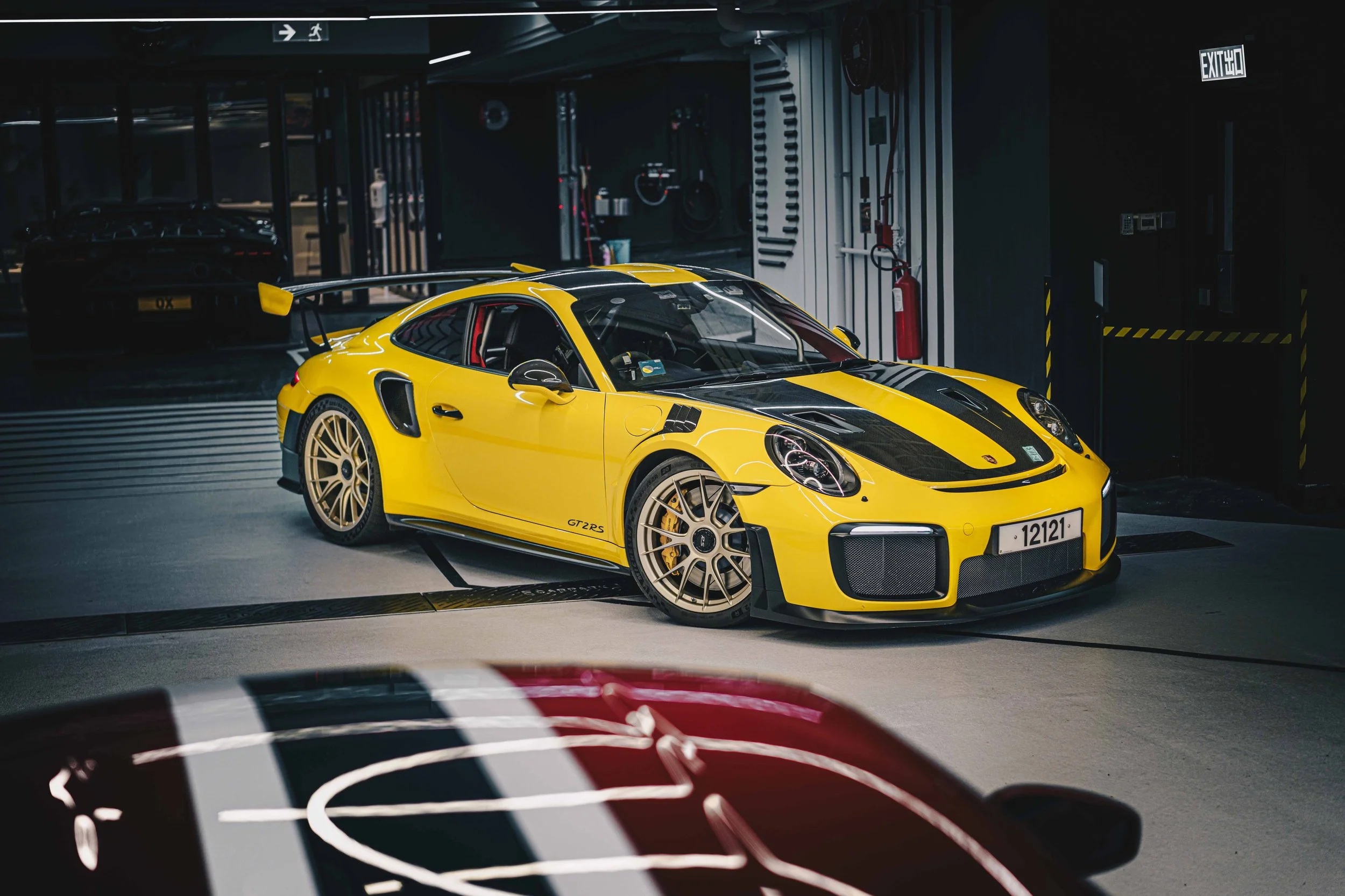 Shibbi Car Detail mobile car detailing completed a full paint correction and premium ceramic coating application on this yellow Porsche 911 GT2RS resulting in a deep wet mirror gloss and hydrophobic protection