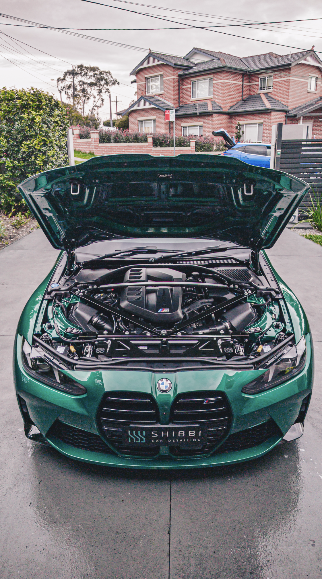 Shibbi Car Detail mobile car detailing completed a full engine bay detail on this green BMW M3 G80 including paint correction and ceramic coating, resulting in a deep wet mirror gloss in a customer's driveway in Rose Bay, Sydney.