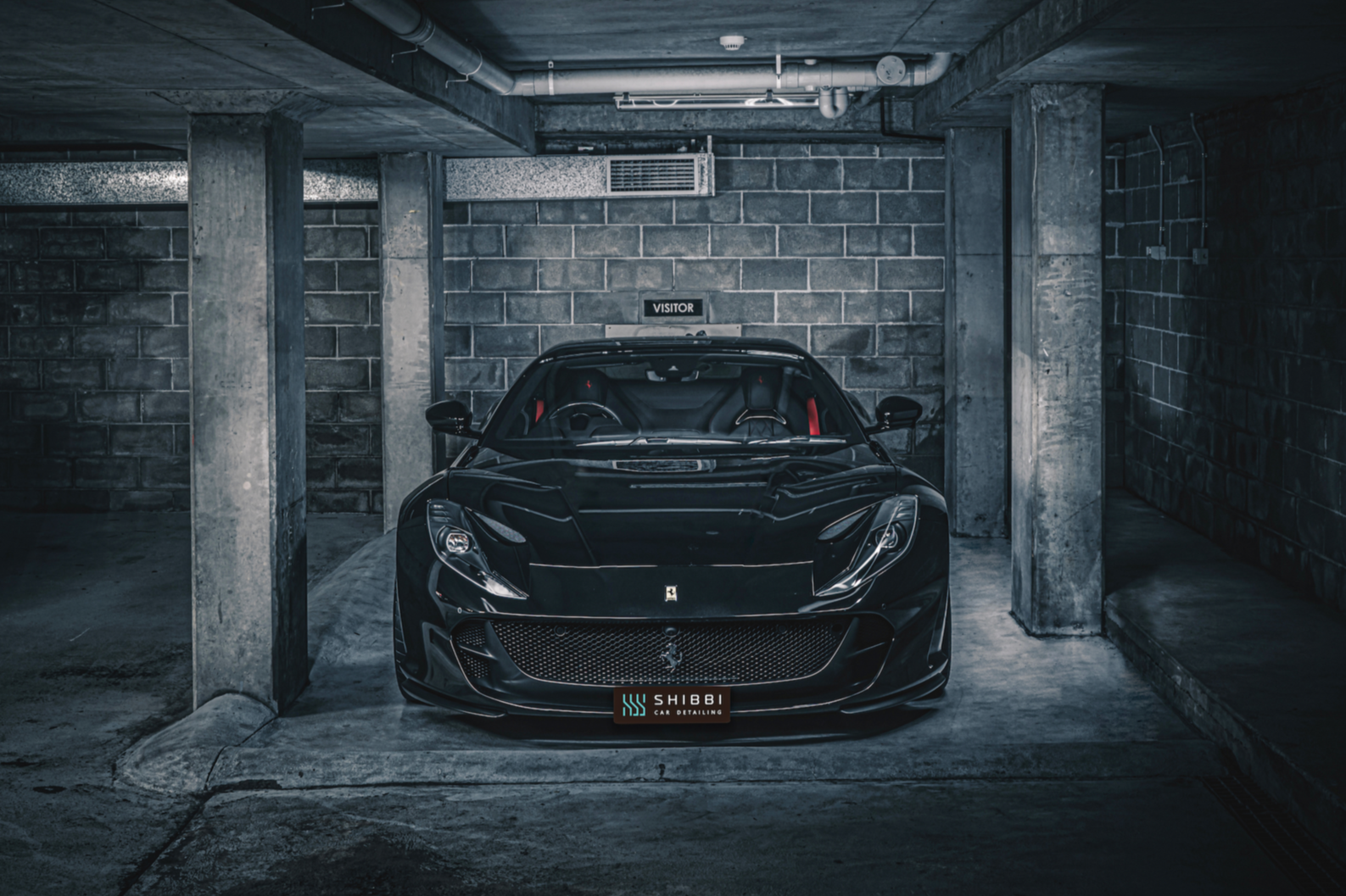 Shibbi Car Detail mobile car detailing applying thick pH neutral snow foam pre-wash to a black Ferrari 812 GTS convertible, allowing the foam to dwell and safely lift dirt and contaminants before pressure rinsing in a customer's driveway in Rose Bay,