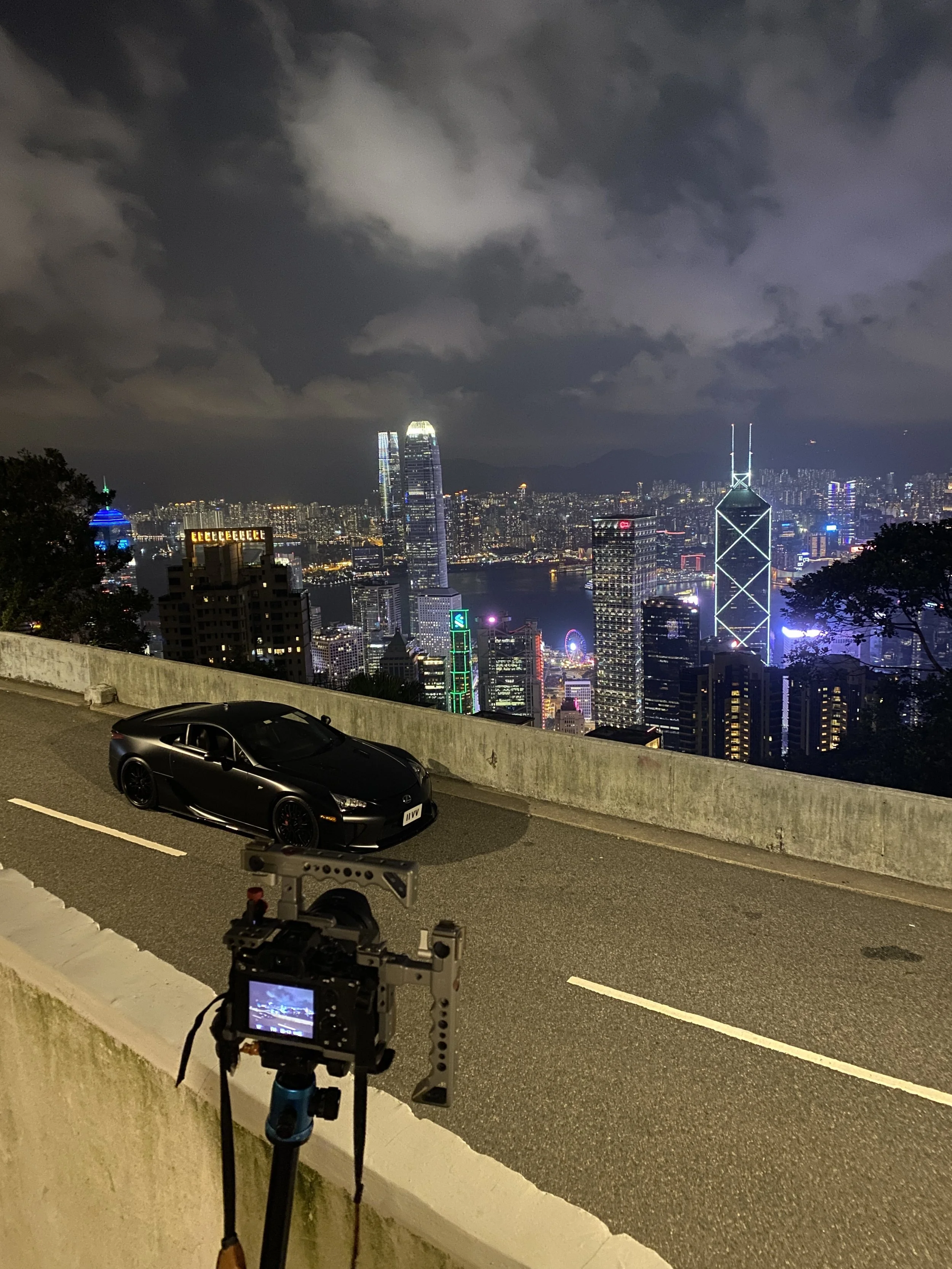 Professional night automotive photography of a Lexus LFA parked under city lights in Hong Kong. Shibbi Automotive Photography.