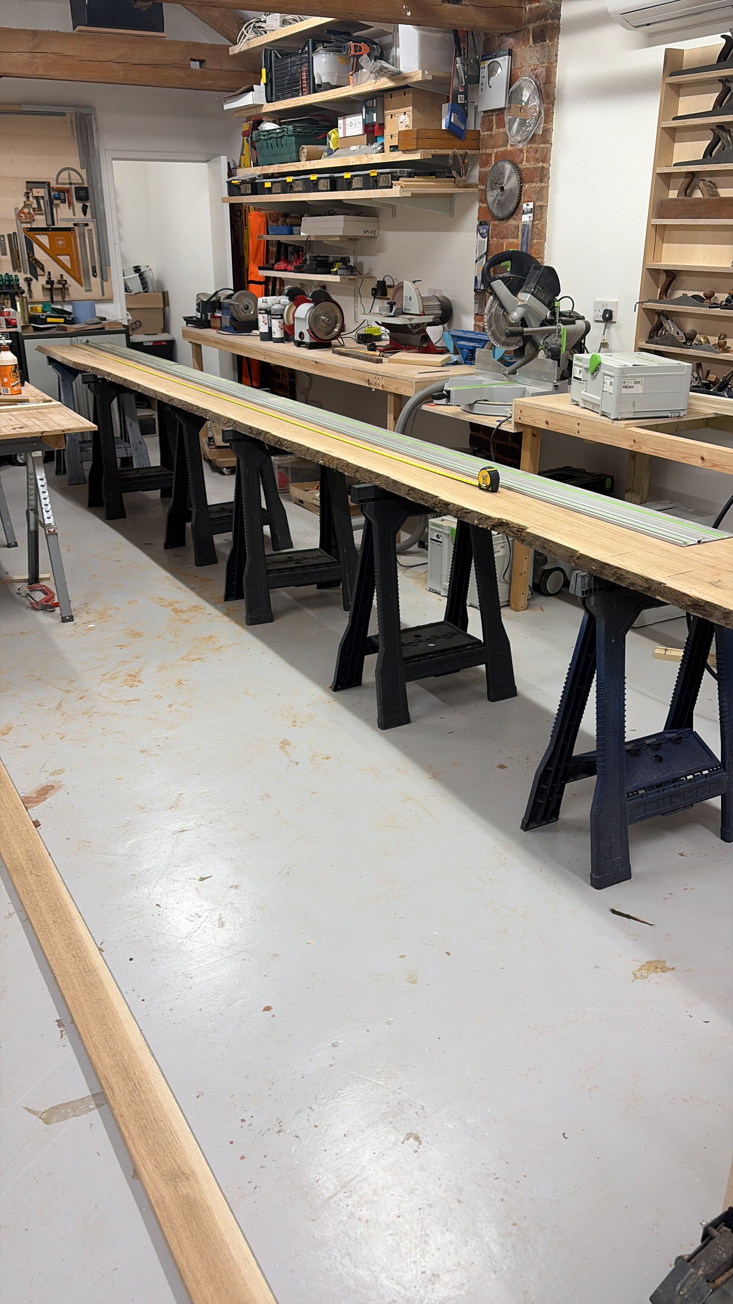 Detail of European oak display cabinet showing grain, cable access and precise joinery for bespoke installation in Notting Hill.