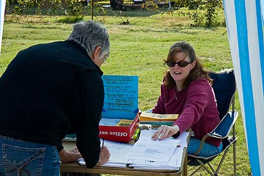 Brenda Bell signs in with Deanne Brices assistance.jpg