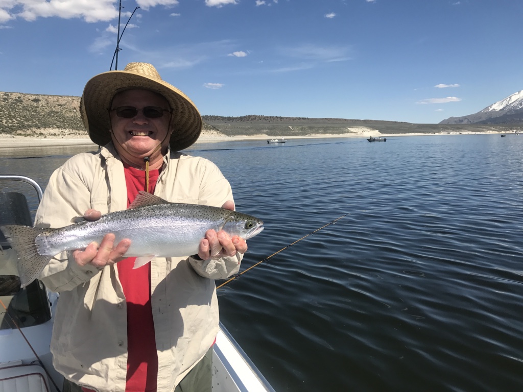 Bishop City Council member Joe Pecsi holds a trophy rainbow trout he caught while midge fishing off of Alligator Point.