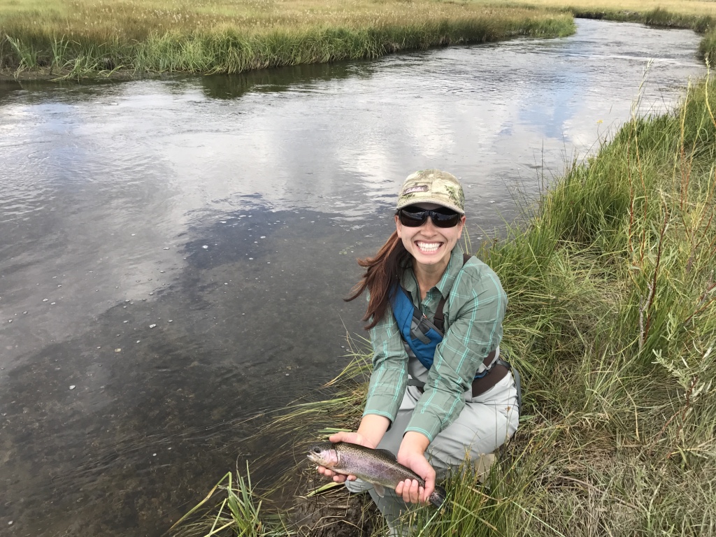 New fly fisher Chelsea Kaplan holds a brown trout she took out of a canal in Bishop.