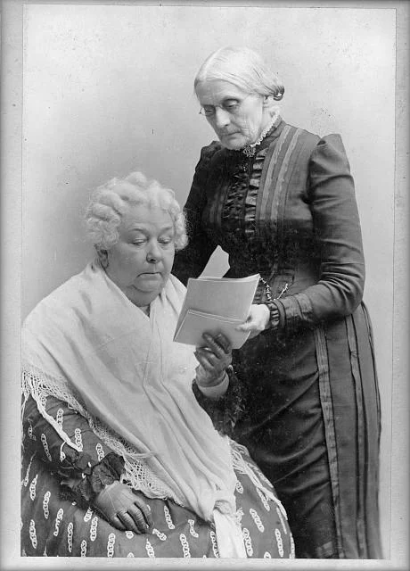 Elizabeth Cady Stanton, seated, and Susan B. Anthony, standing, three-quarter length portrait