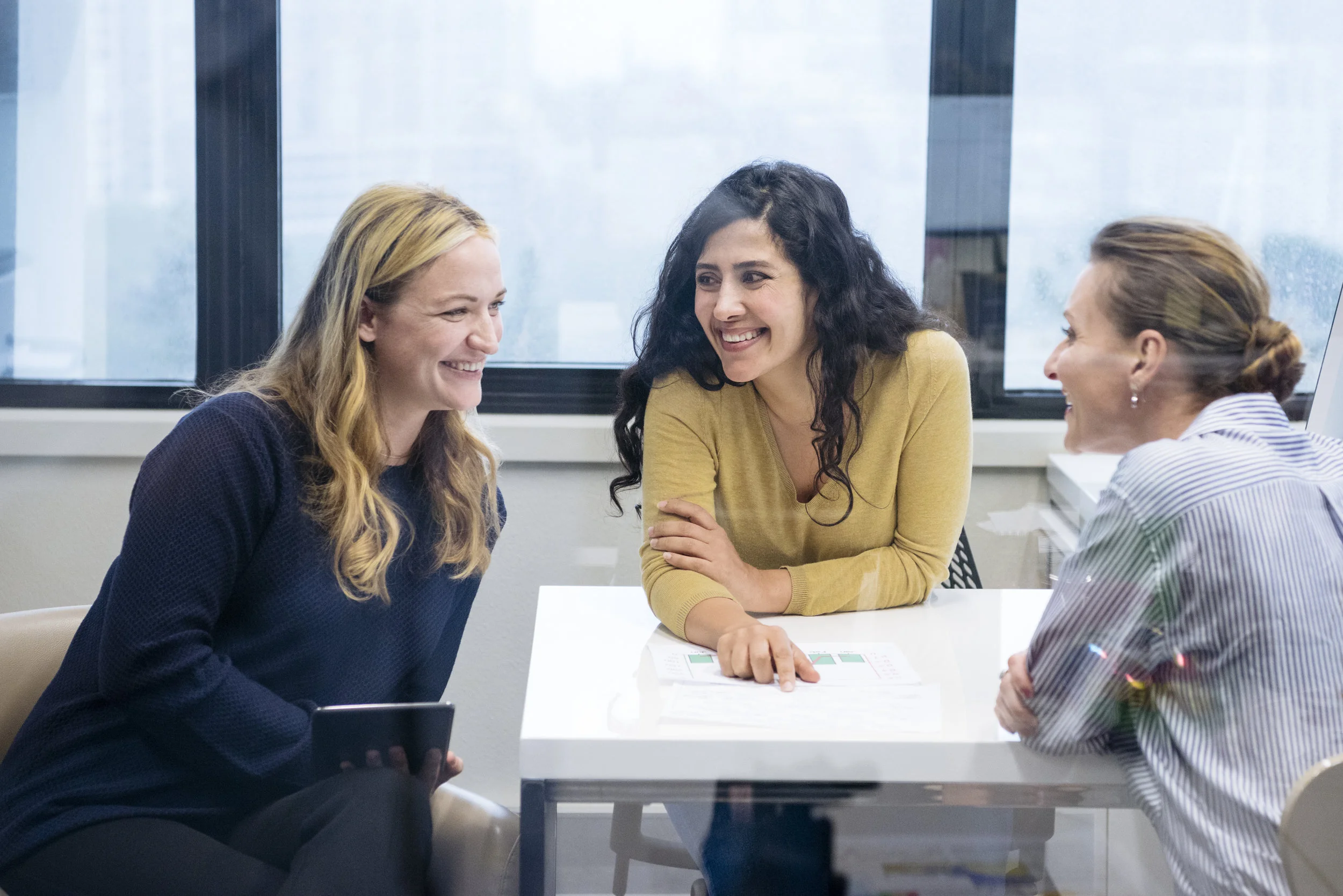 Three-multi-racial-businesswomen-in-meeting,-smiling-604341202_6119x4084.jpeg