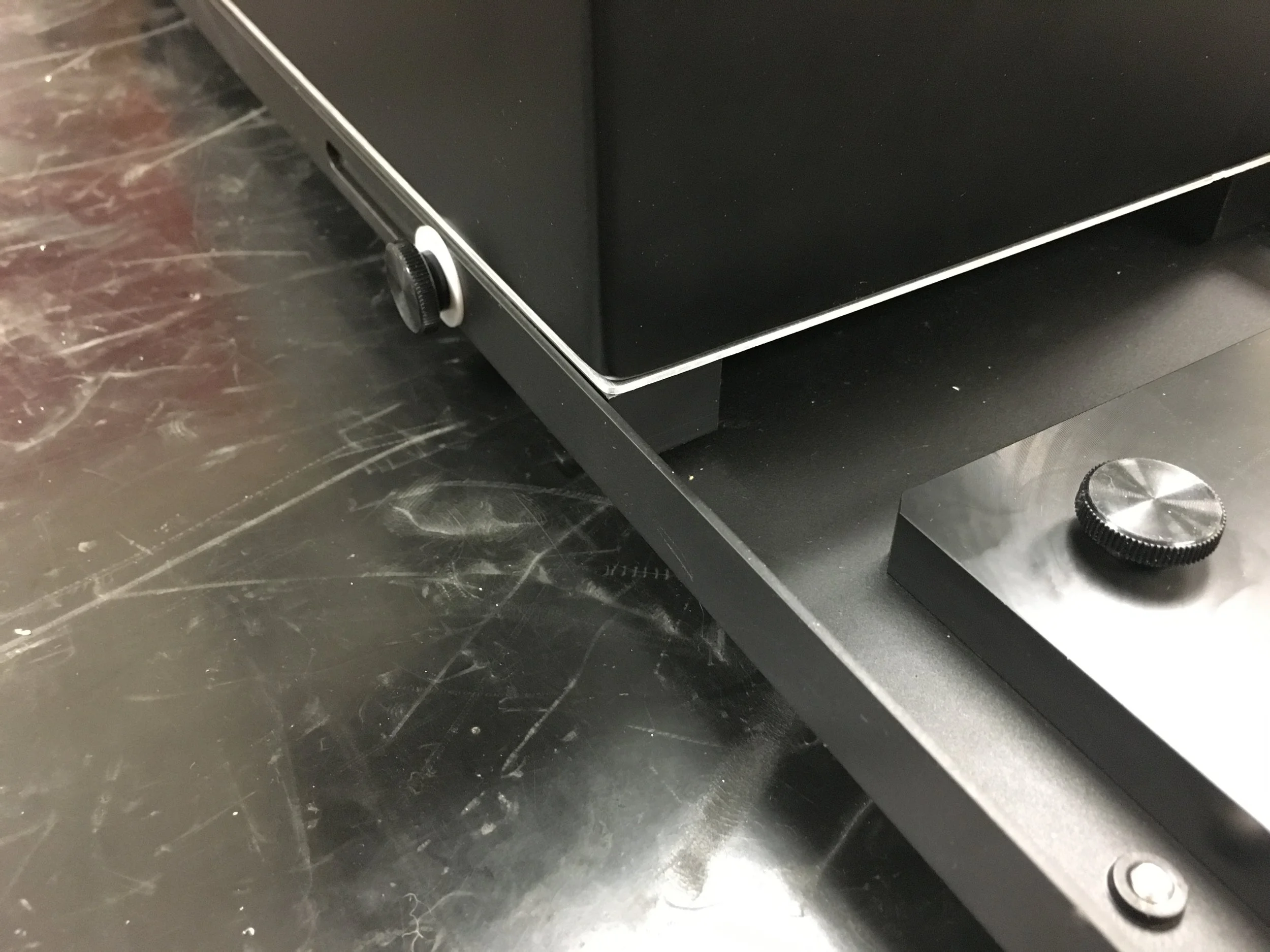  I designed custom guide rails to replace the rubber feet that were standard on this pump. These external rails matched the slots along the edge on the trays where thumb screws could be used for assembly.&nbsp; 