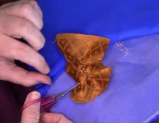 Carefully cut away to approximately 1/4” to 1/2” from buttonhole all around.