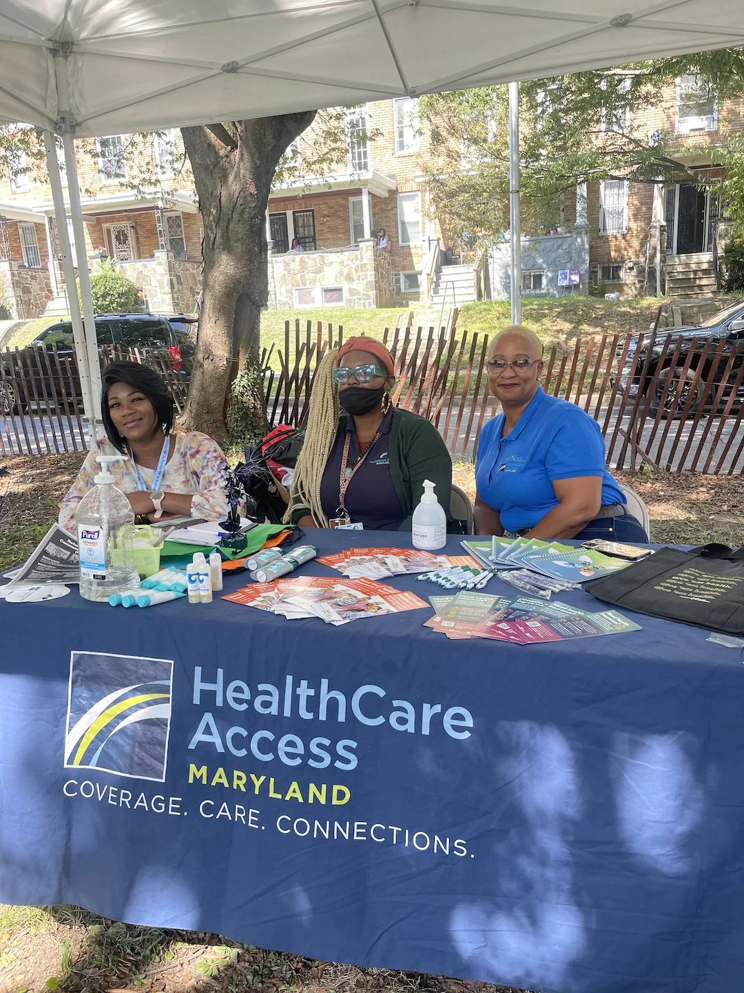 Image of HealthCare Access Maryland staff members at an information booth in the park