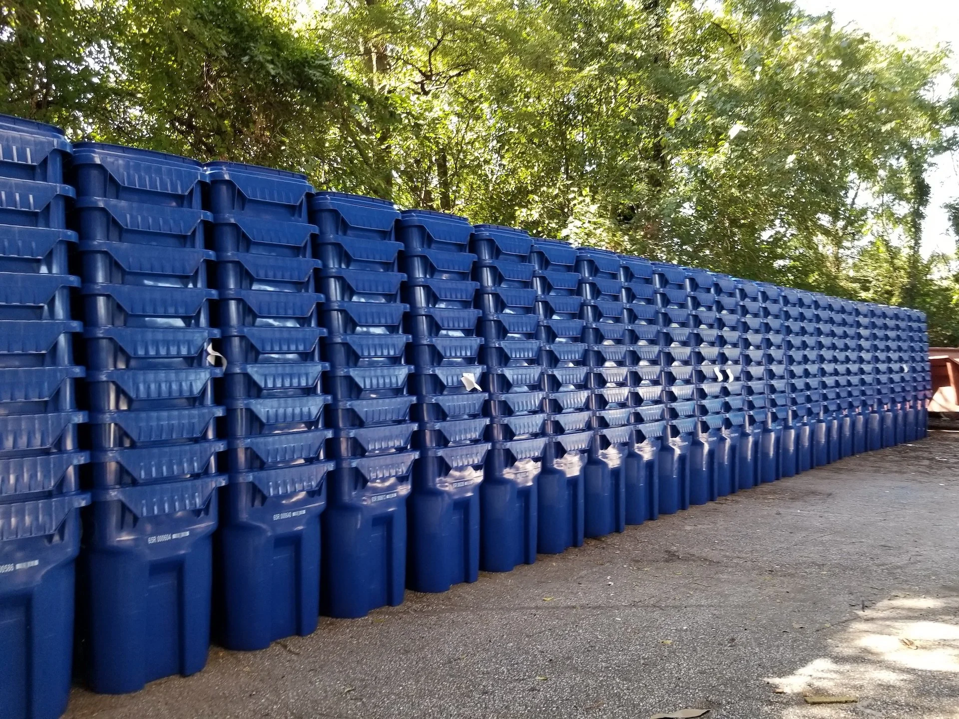 image of dozens of blue household recycling bins