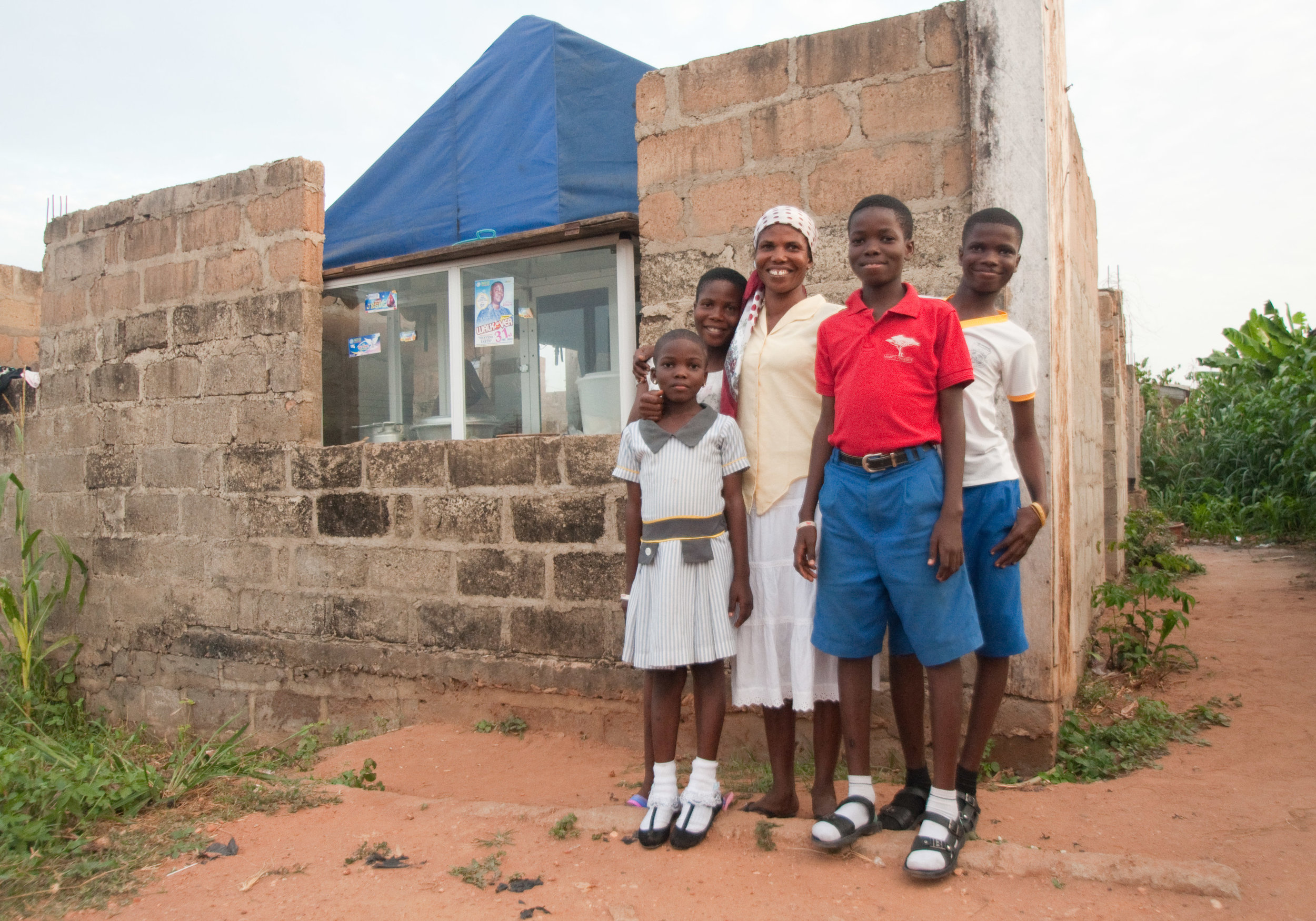 Rejoice and her 4 children outside her shop